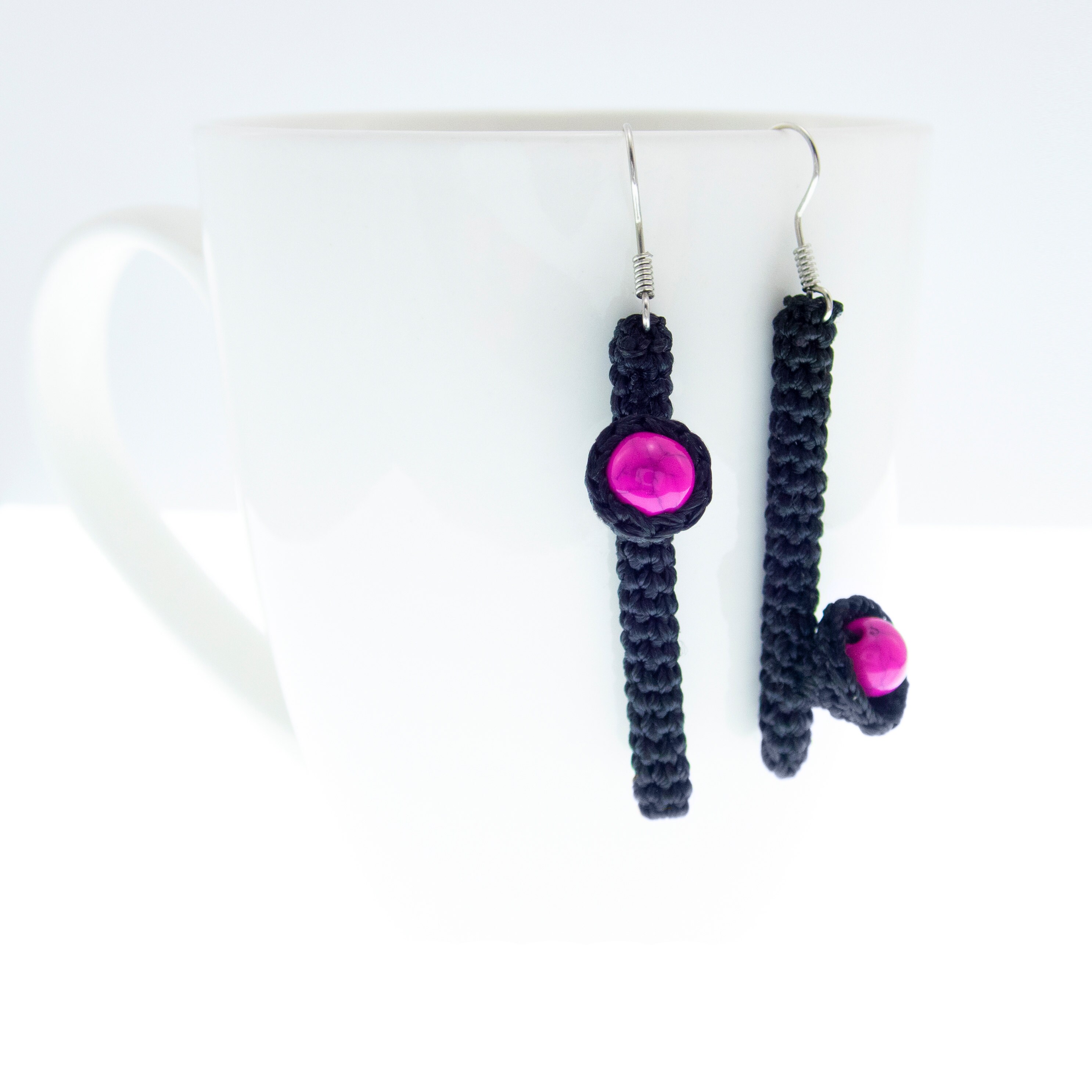 handmade mismatched earrings dangle in black and pink