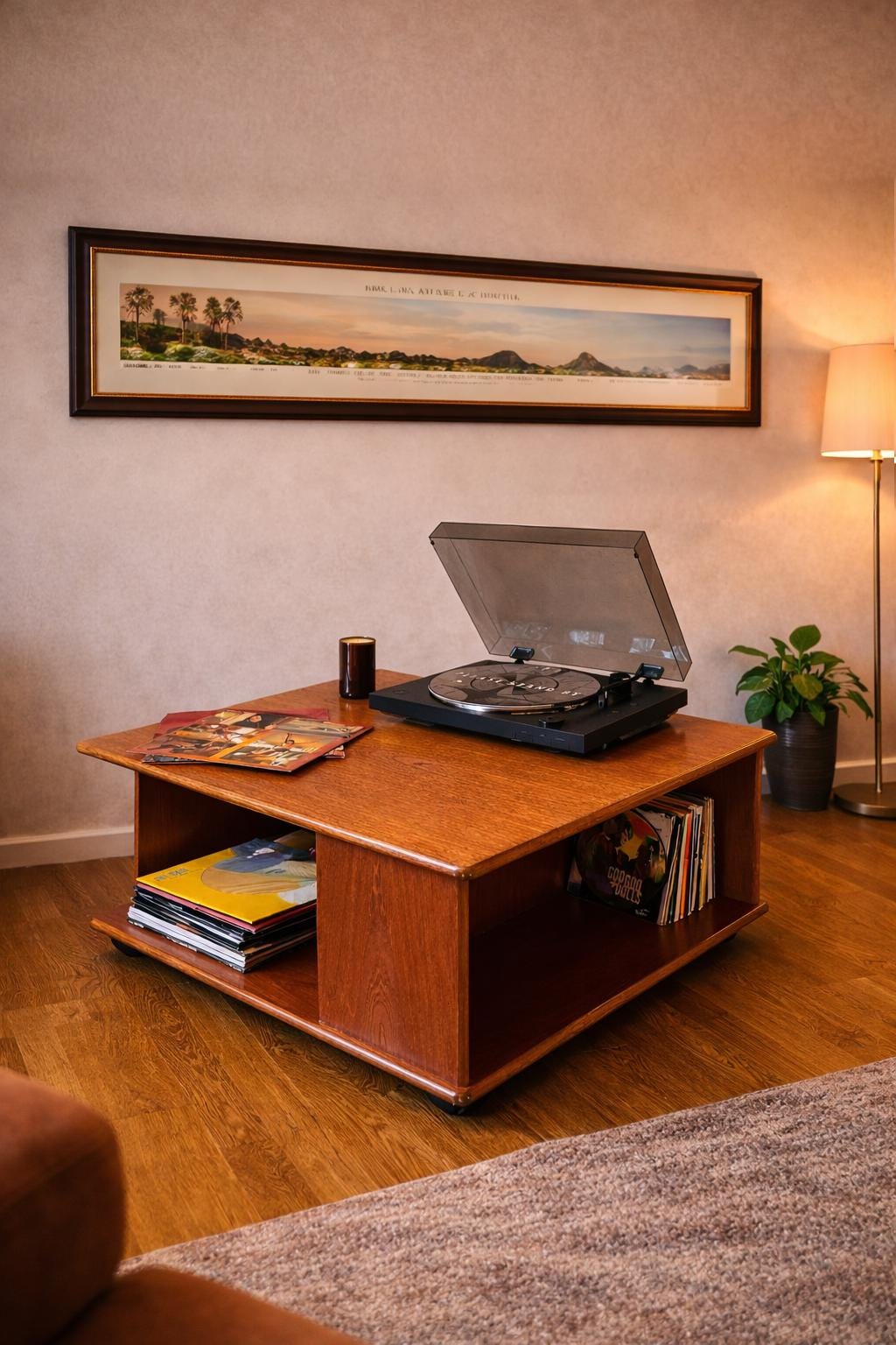 A Nathan Mid Century coffee table sits below a well framed panoramic print