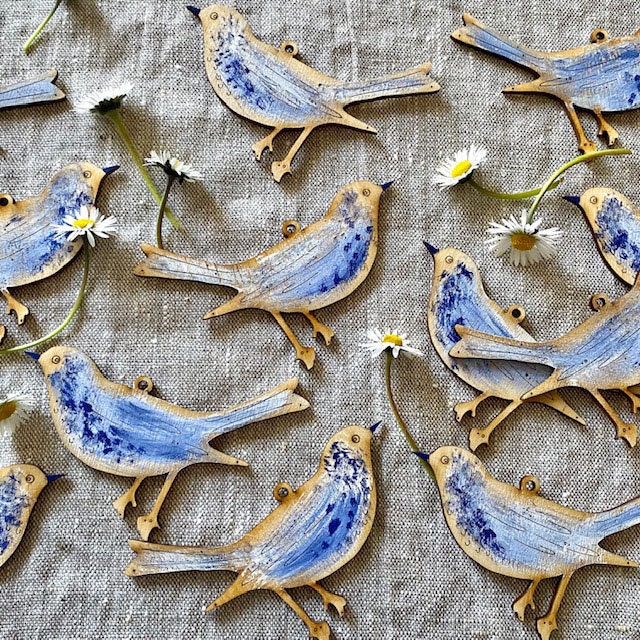 picture of hand painted laser cut wooden birds with blue and white paint effect