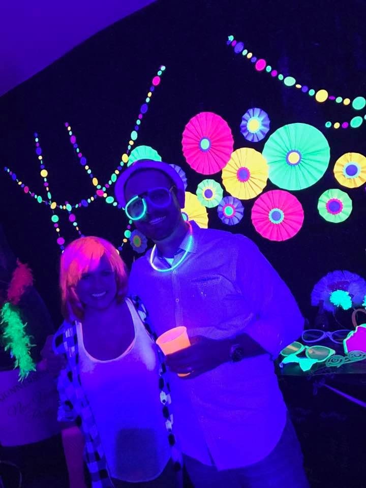 neon poster board folded into paper rosettes for a black light glow party