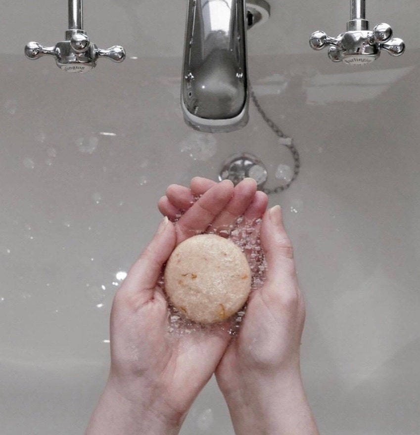 hands holding shampoo bar