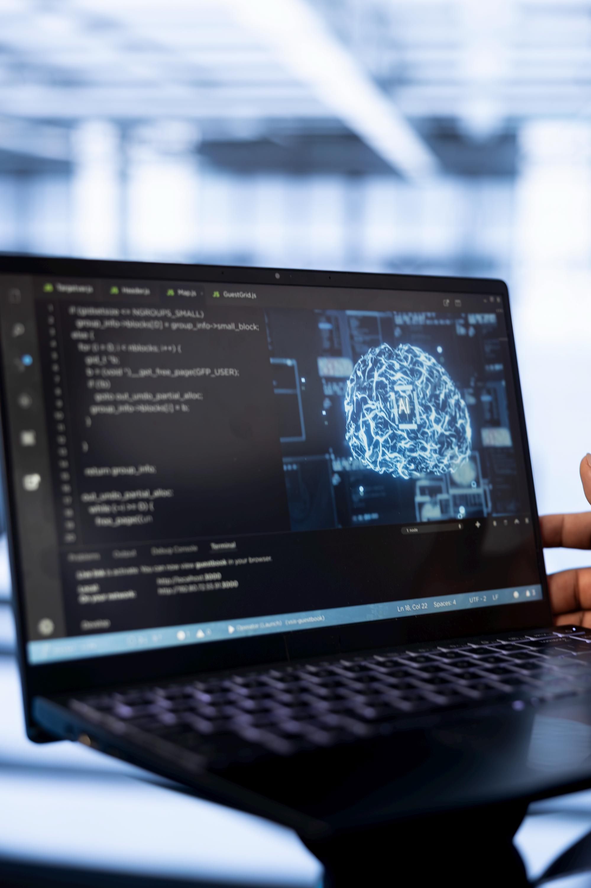 A computer scientist using laptop data center updating ai.