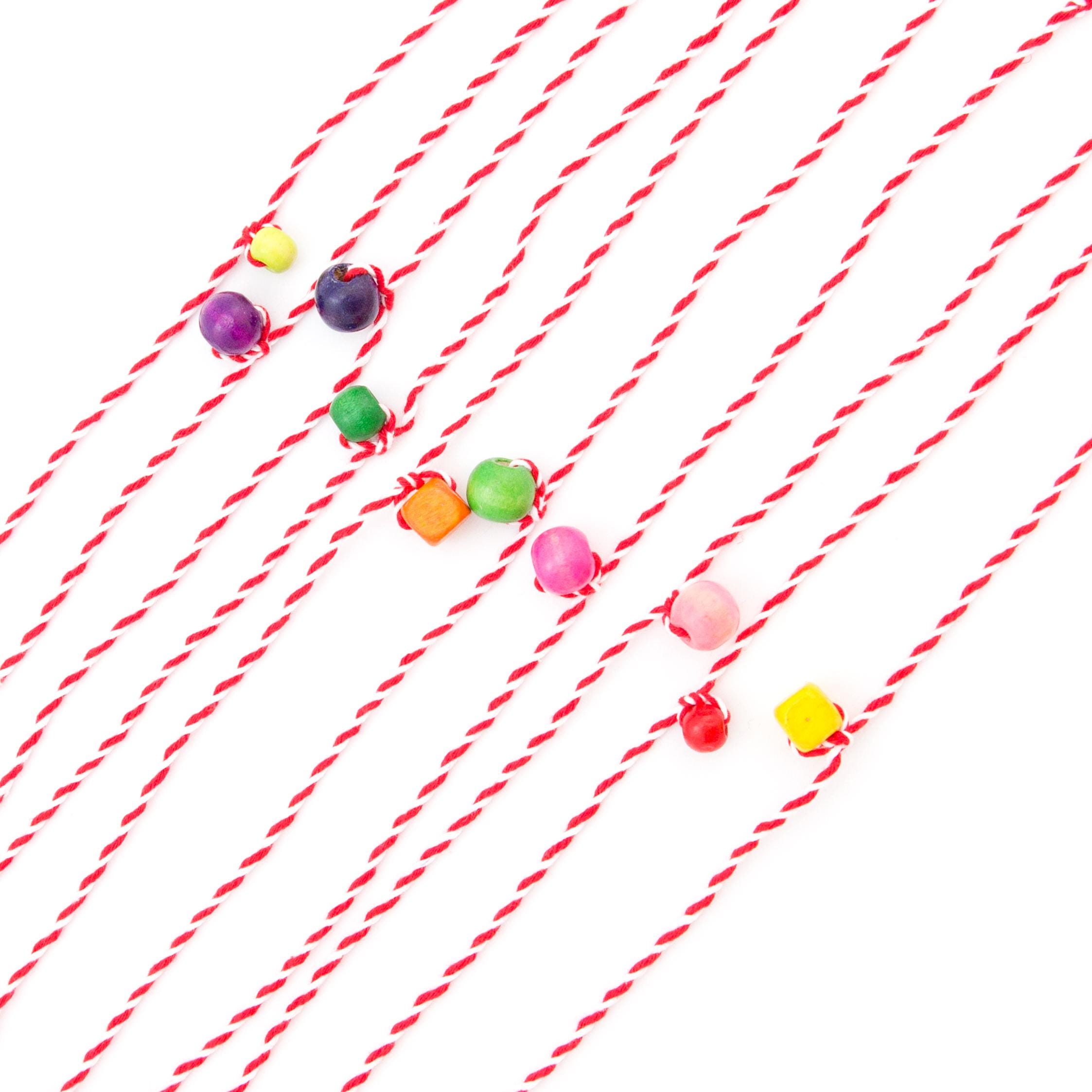 Set of 10 Martenici bracelets made from red and white twisted cotton with wooden bead accents Nadamlada