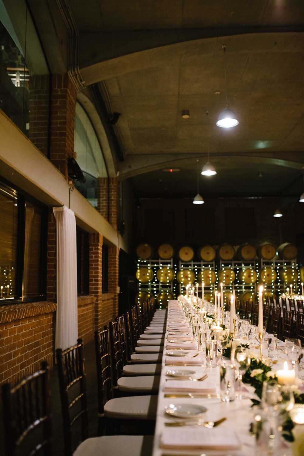 Photo of tables and tiffany chairs styled for an evening wedding reception