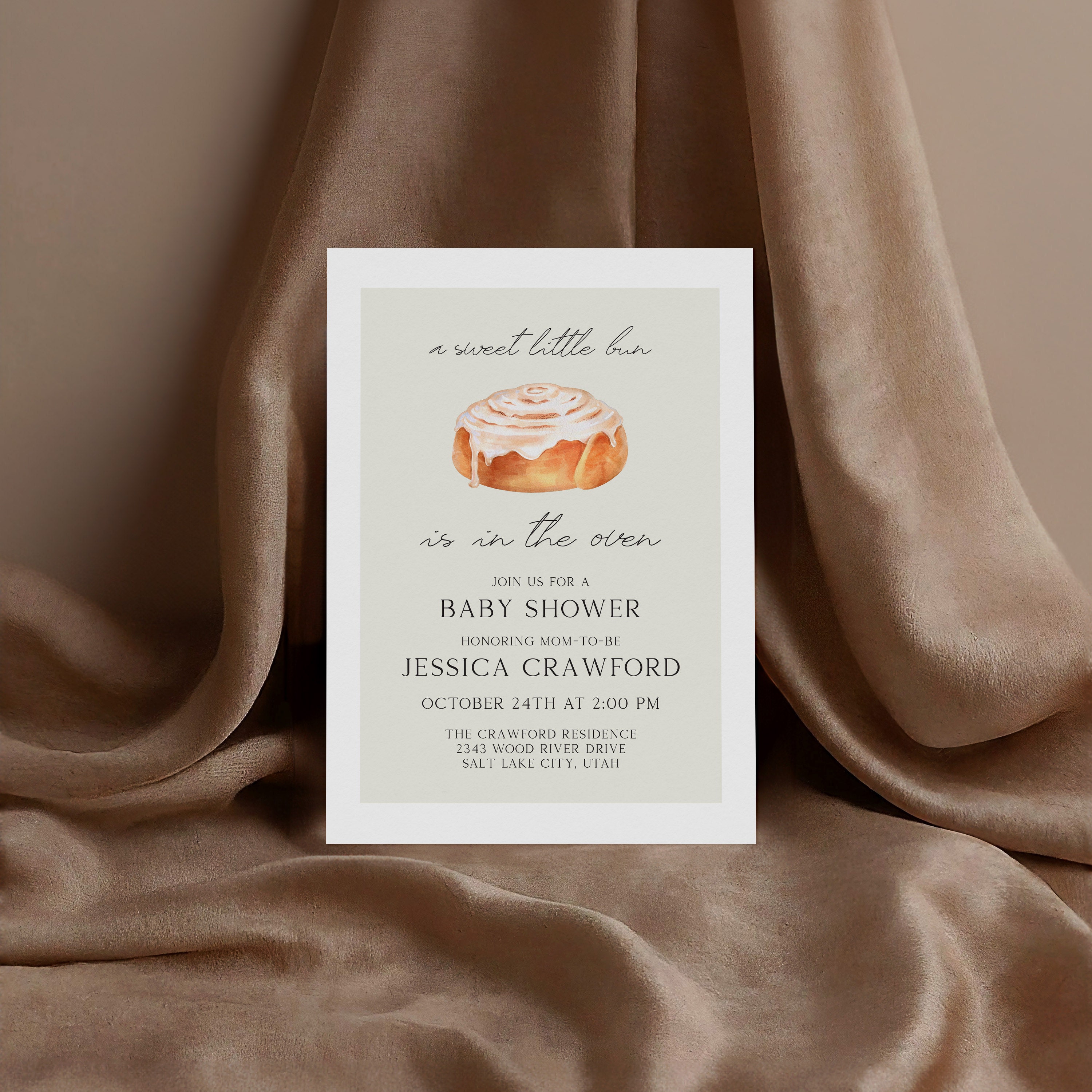 baby shower invitation in front of a brown background