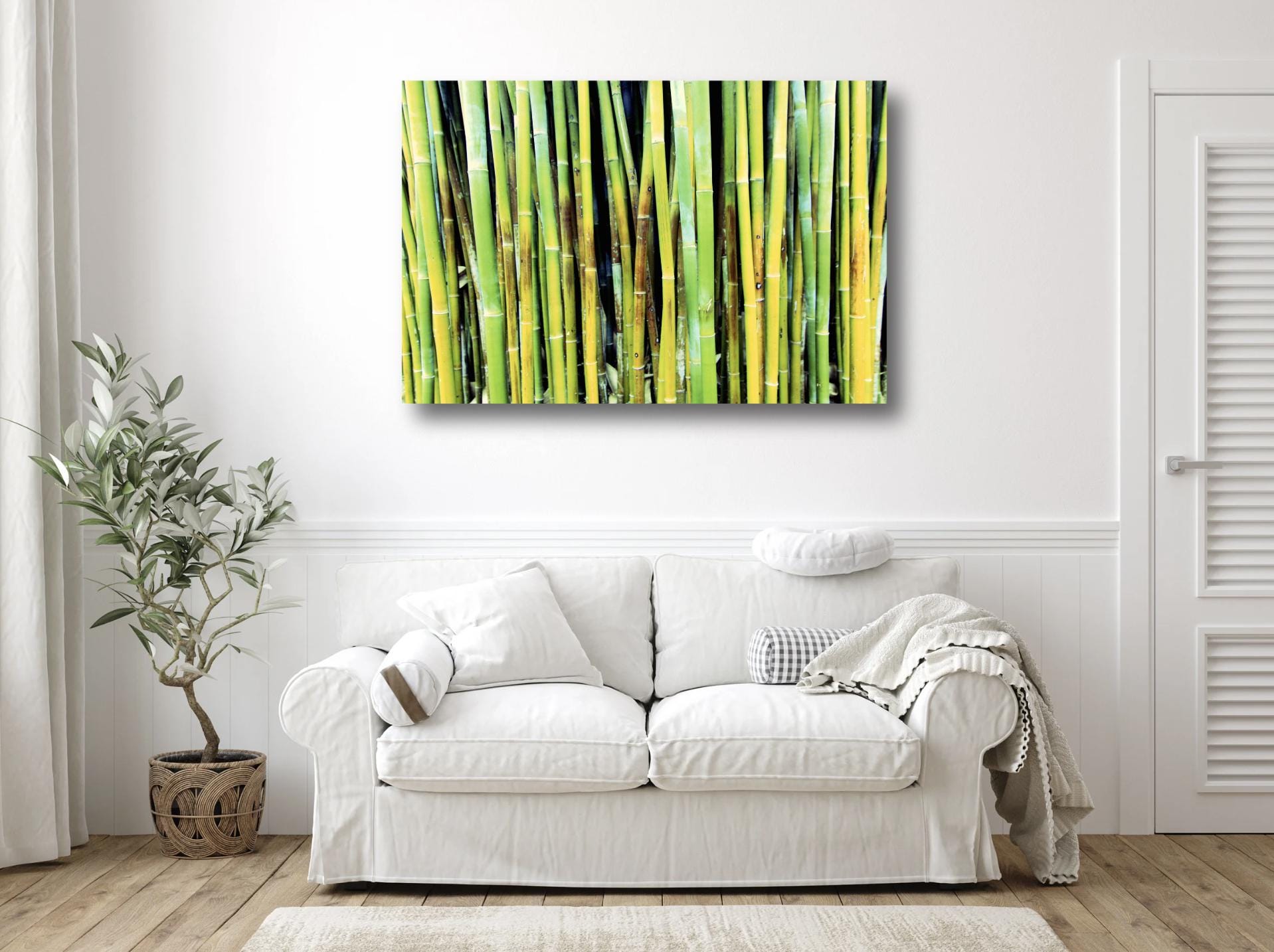 Bold bamboo print above a loveseat