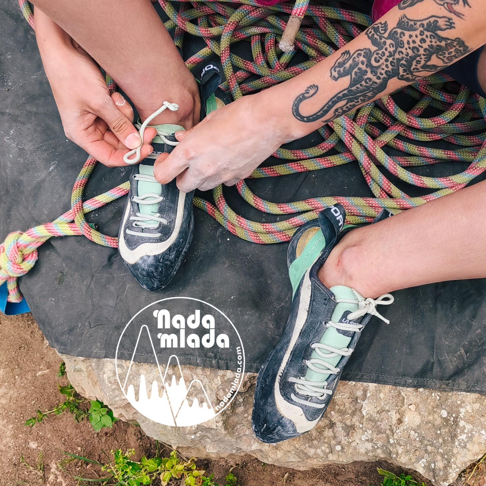 Rock climbing girl preparing to climb, lacing her shoes and getting ready to attach her handmade Nadamlada chalk bag to her harness