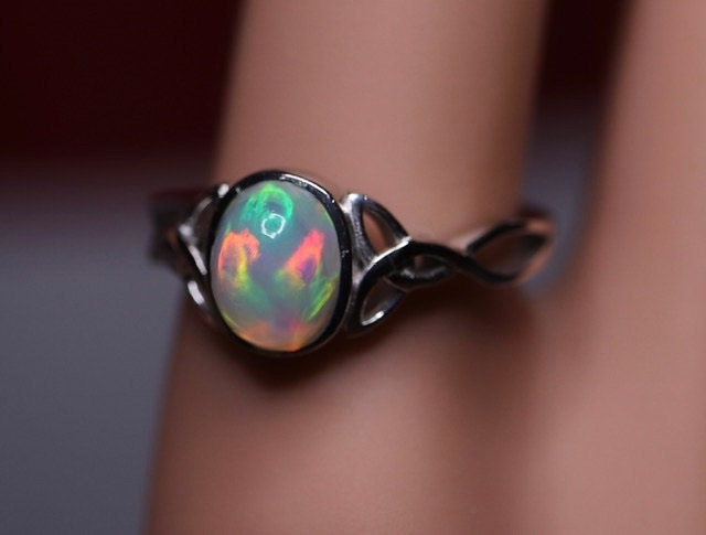 Celtic cabochon ring - perfectly made with a stunning opal and gorgeous ring setting plated with rhodium over sterling silver. Priced ridiculously low and you cannot find anything even remotely similar to this in quality anywhere that’s not at least $700! Check out my price:)
