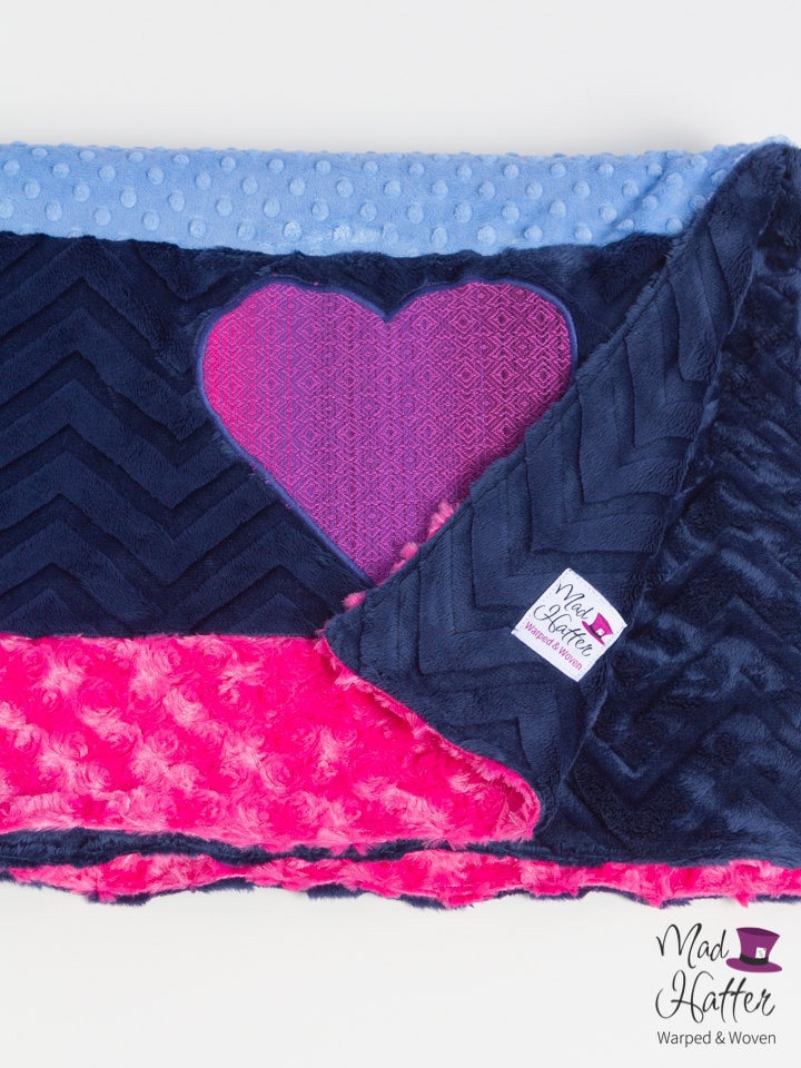 Mad Hatter Warped & Woven Minky Blanket with strips of hot pink, dark blue, and light blue minky and a wrap scrap heart.