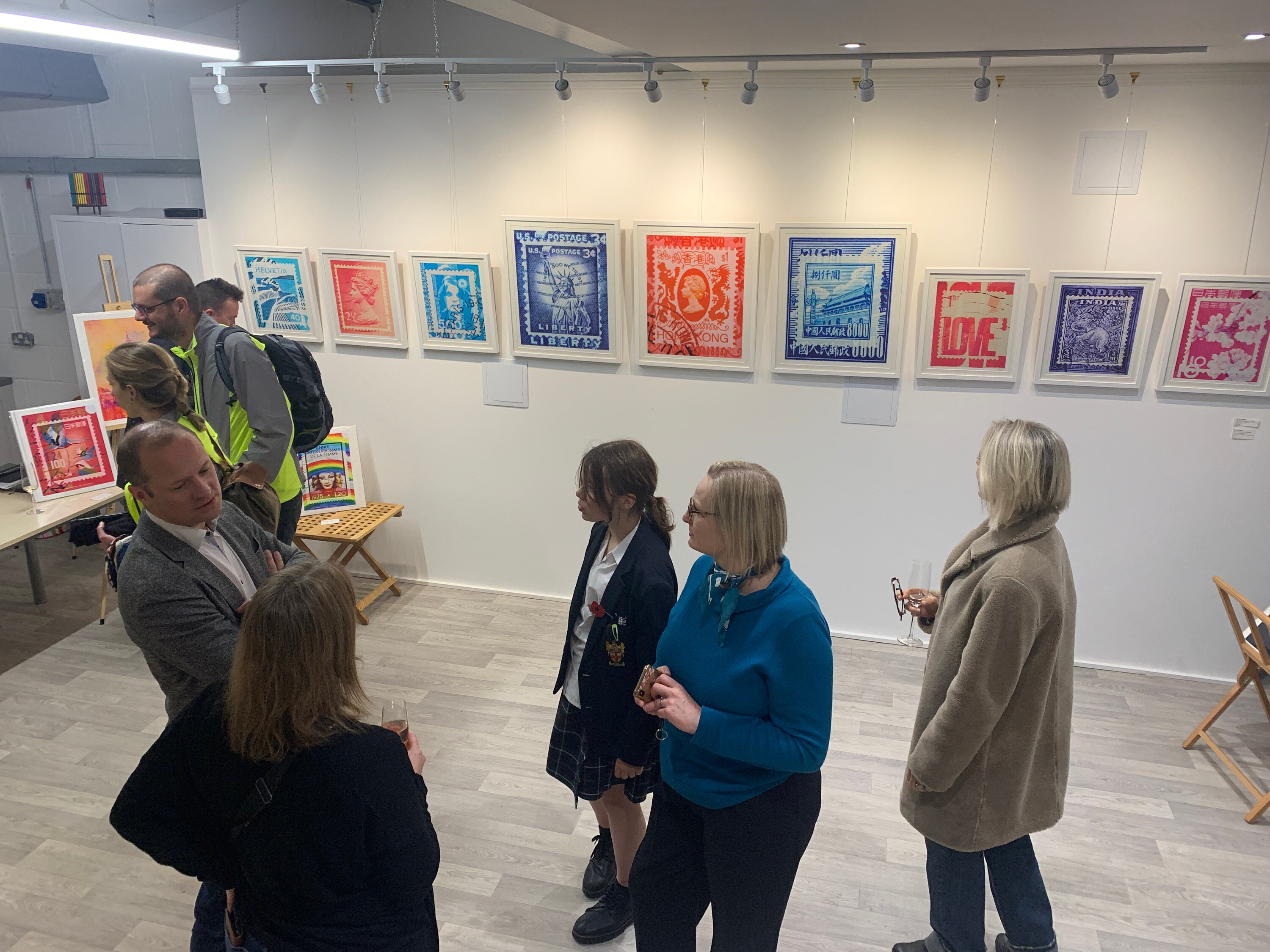 Deborah Pendell Fine Art solo art exhibition at Cambridge Art Cube- people milling around looking at Stamp Collection art