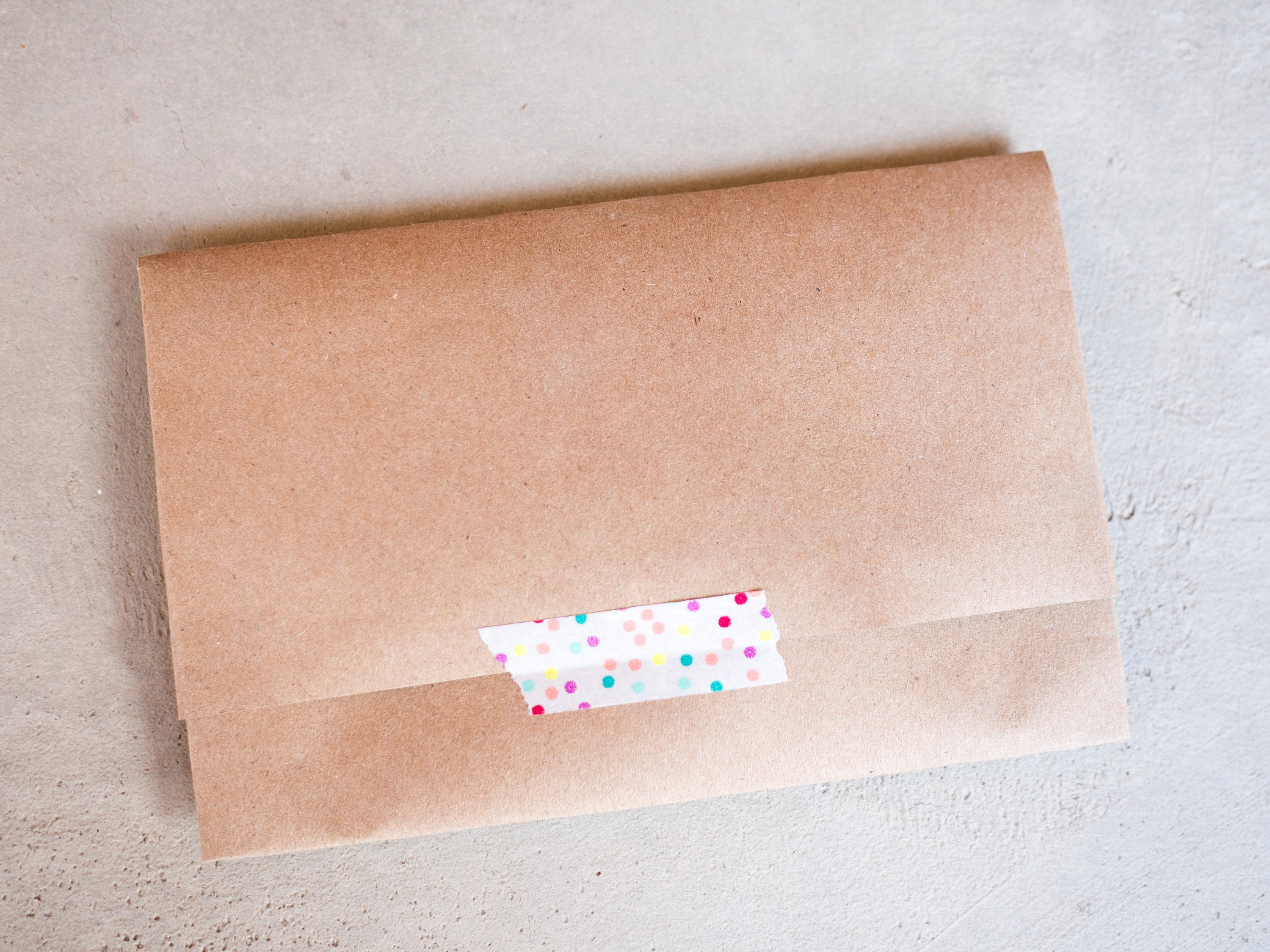Tape the flaps closed with a little bit of colorful washi tape