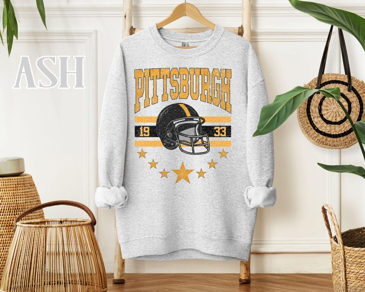 Ash Gray crewneck sweatshirt featuring Pittsburgh 1933 retro football helmet graphic with stripes and stars—fan-safe design
