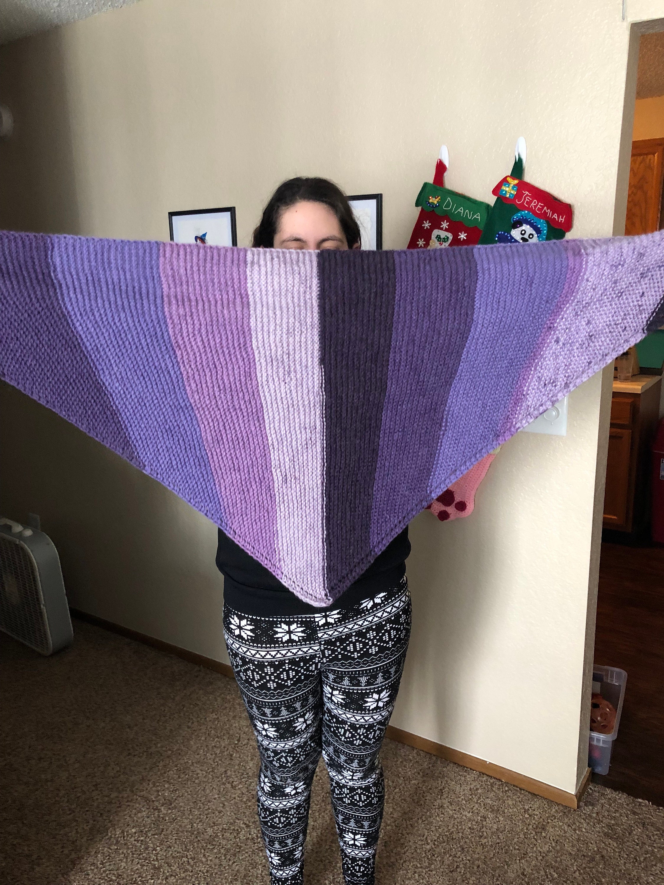 Woman holding purple knit scarf
