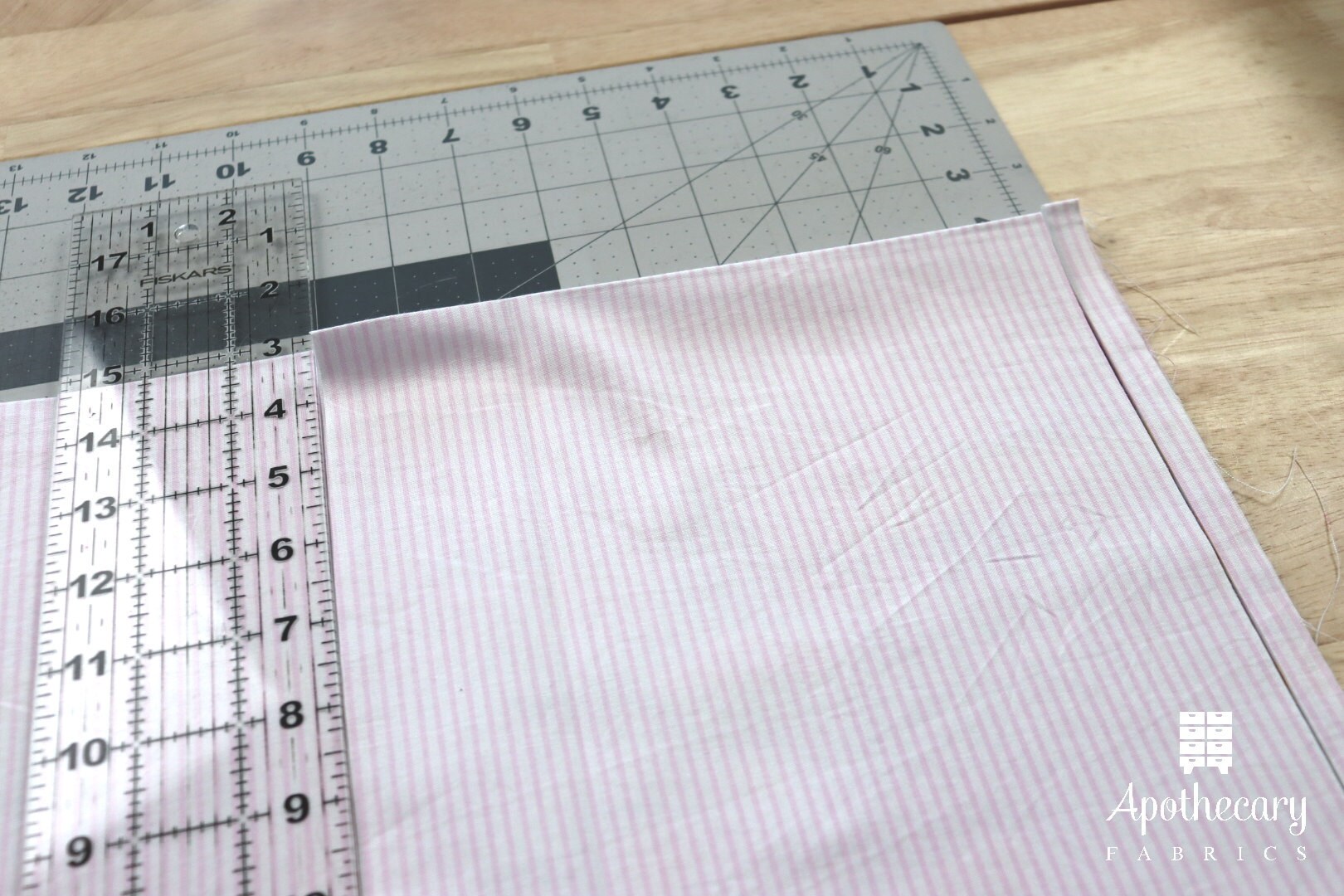 Cutting fabric from selvedge to selvedge.