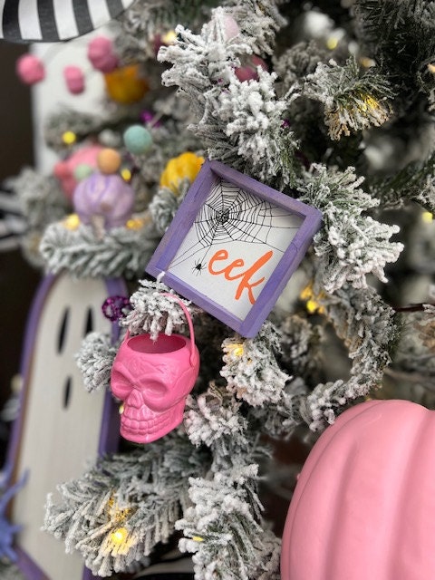 mini sign that says eek with surrounding pumpkins