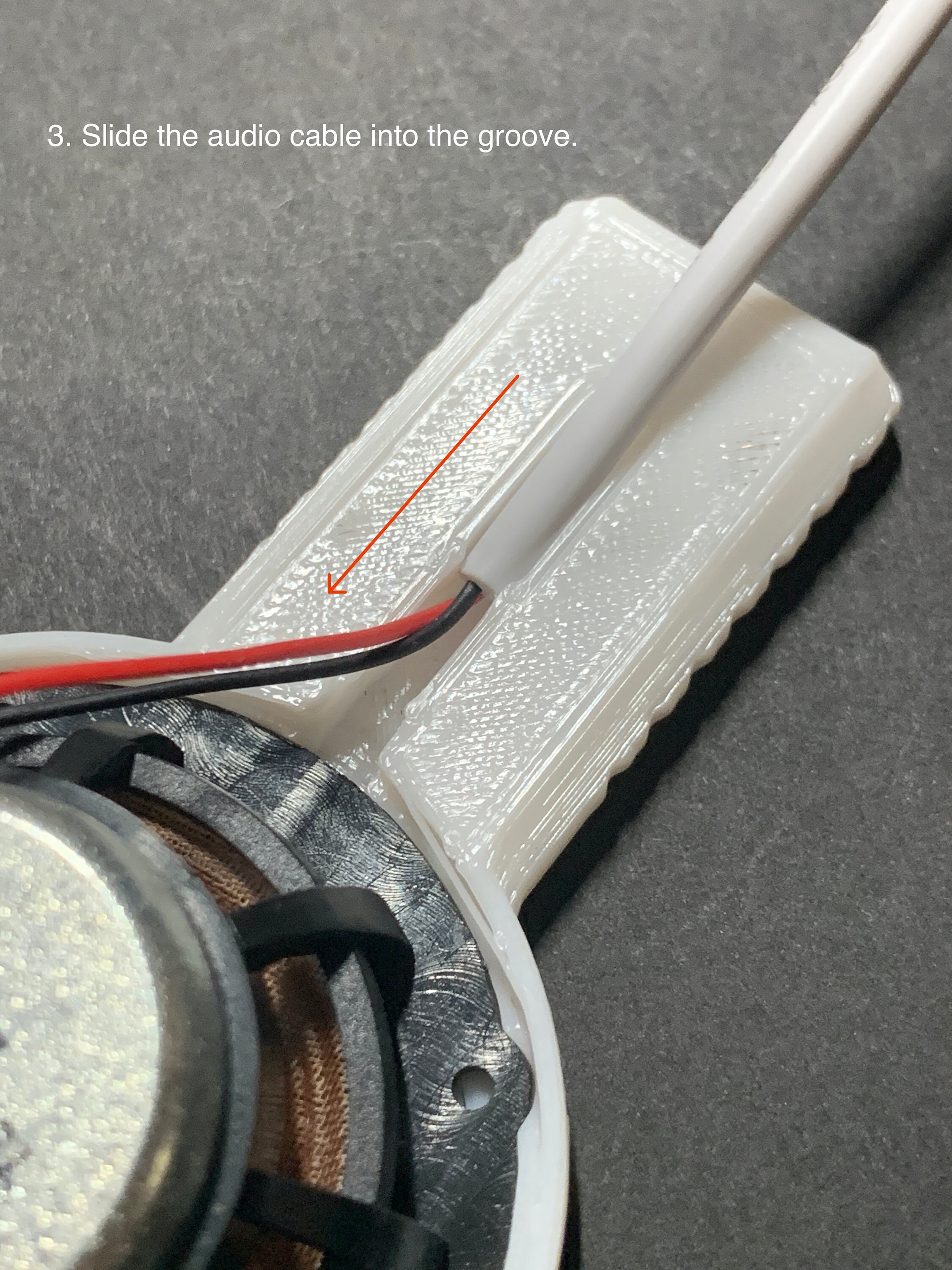 3. Slide the audio cable into the groove.