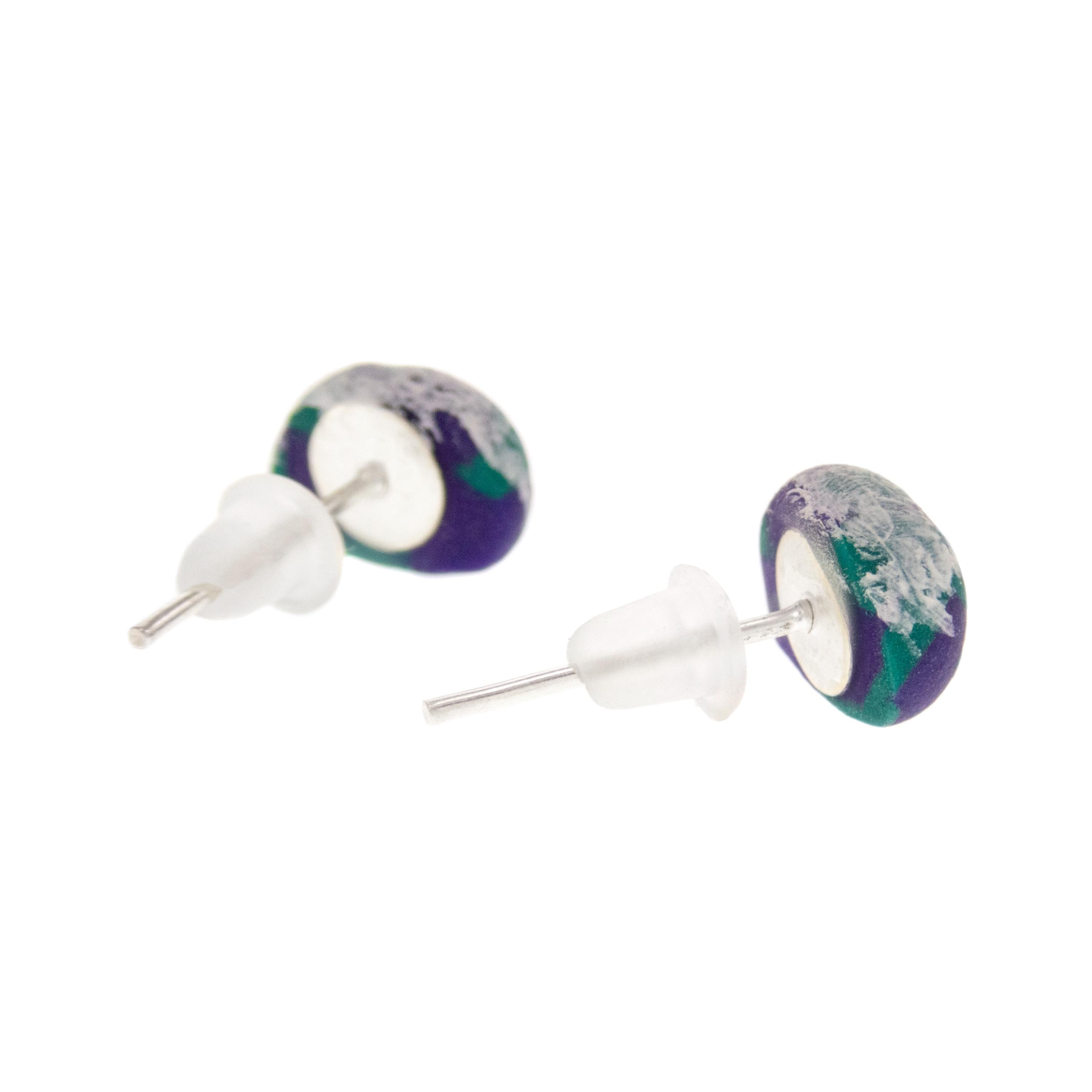 Small climbing gear-inspired studs worn as casual fashion jewelry