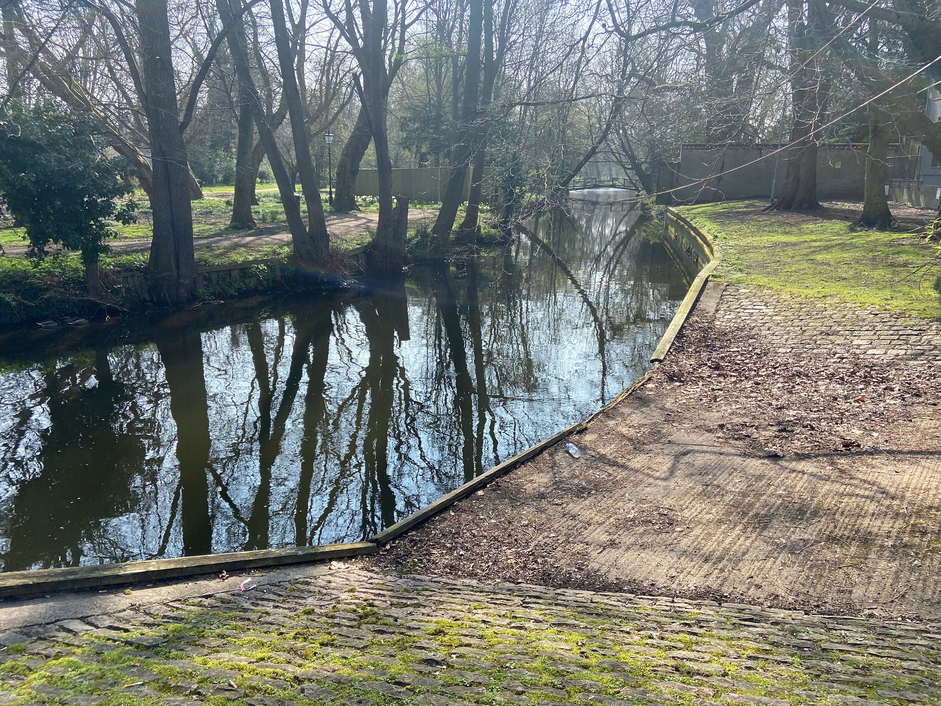 River with trees in the background. Shows lowered section of bank