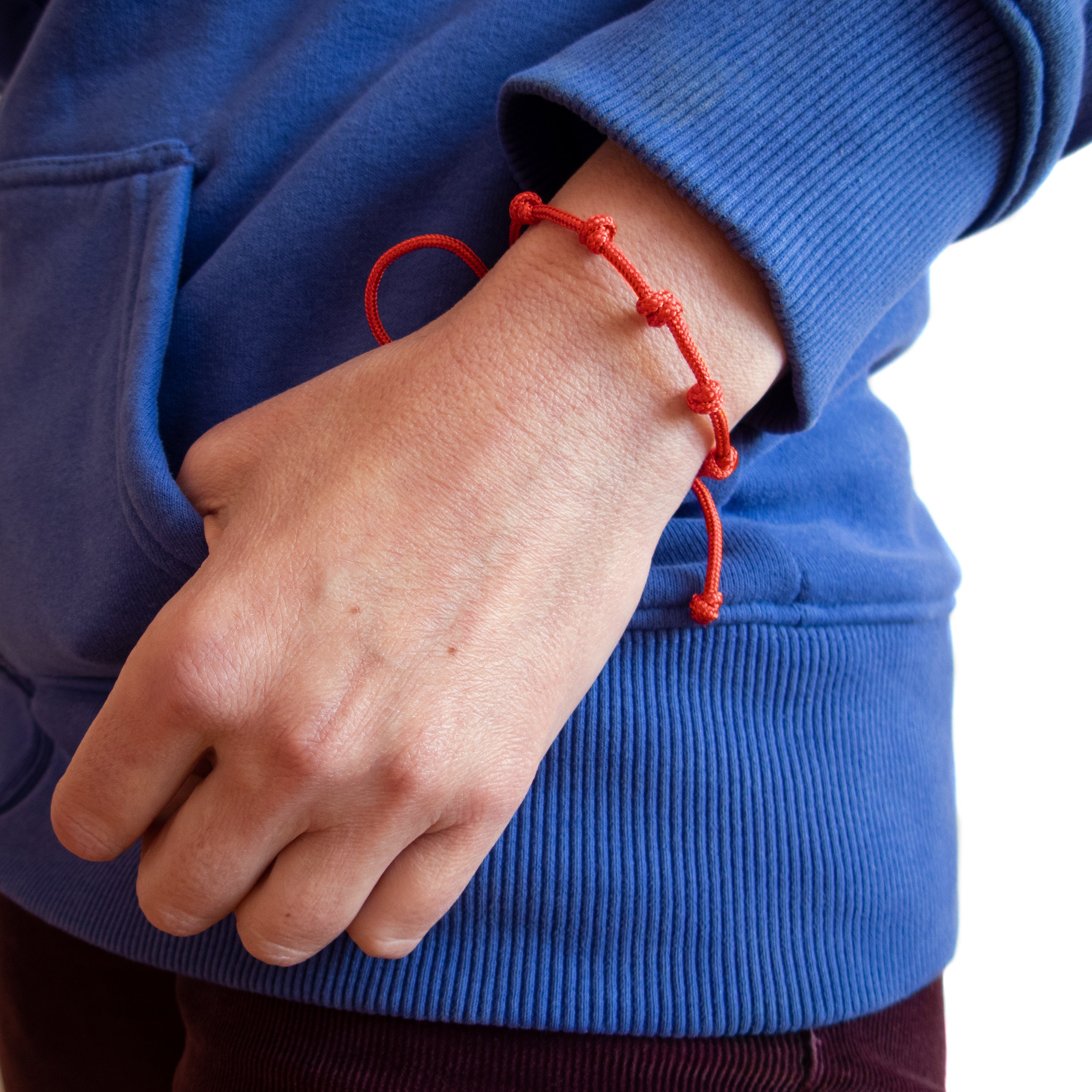 handmade red string bracelet with 7 knots