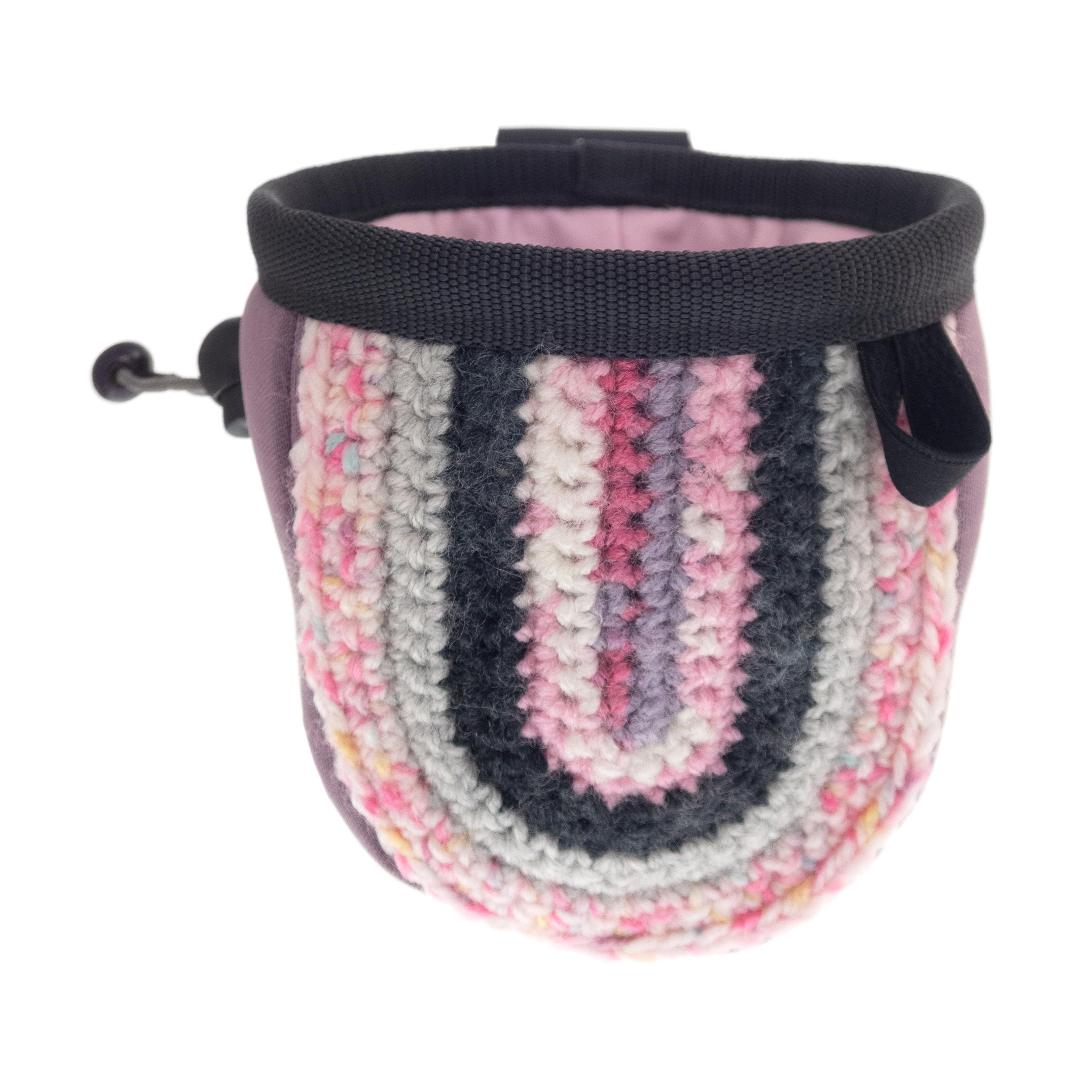 Small pink chalk pouch hanging from climbing gear, created for childrens climbing and bouldering sessions.