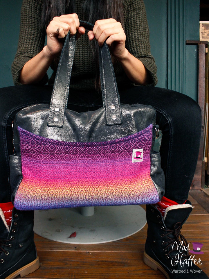 A woman holding a Mad Hatter Warped & Woven Lovato handbag featuring Heartfelt colourway and Silver Foil leather