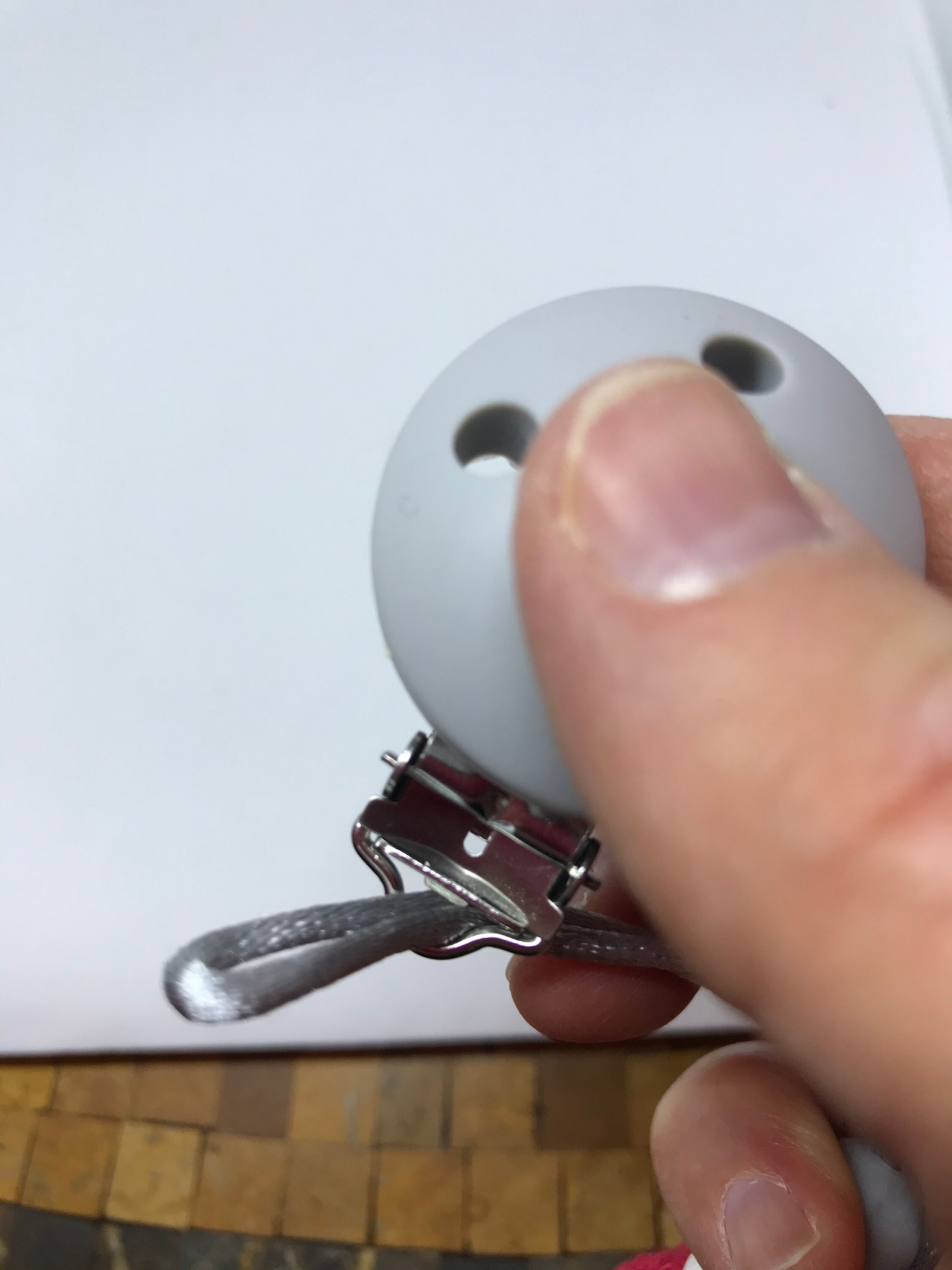 Loop through the end of the pacificer clip.