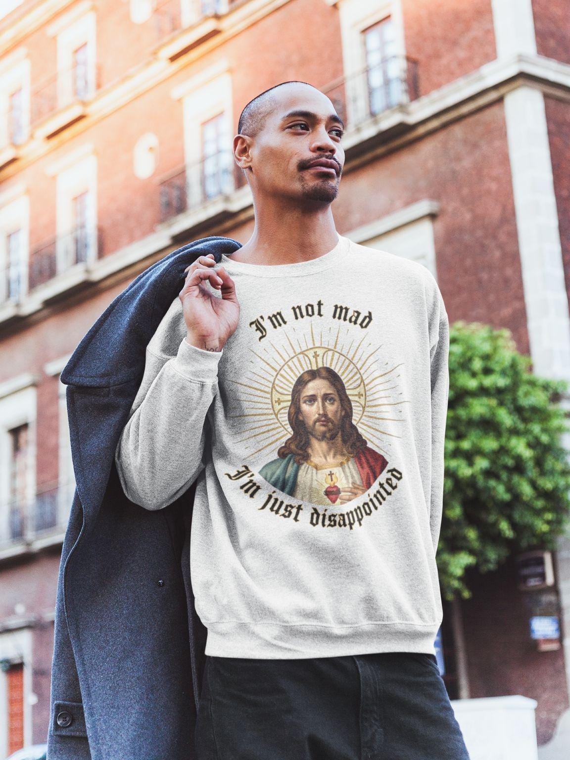 Graphic design of Renaissance-style Jesus with a tearful, disappointed expression. Gothic text above and below reads Im not mad, Im just disappointed, in the style of a popular internet meme.