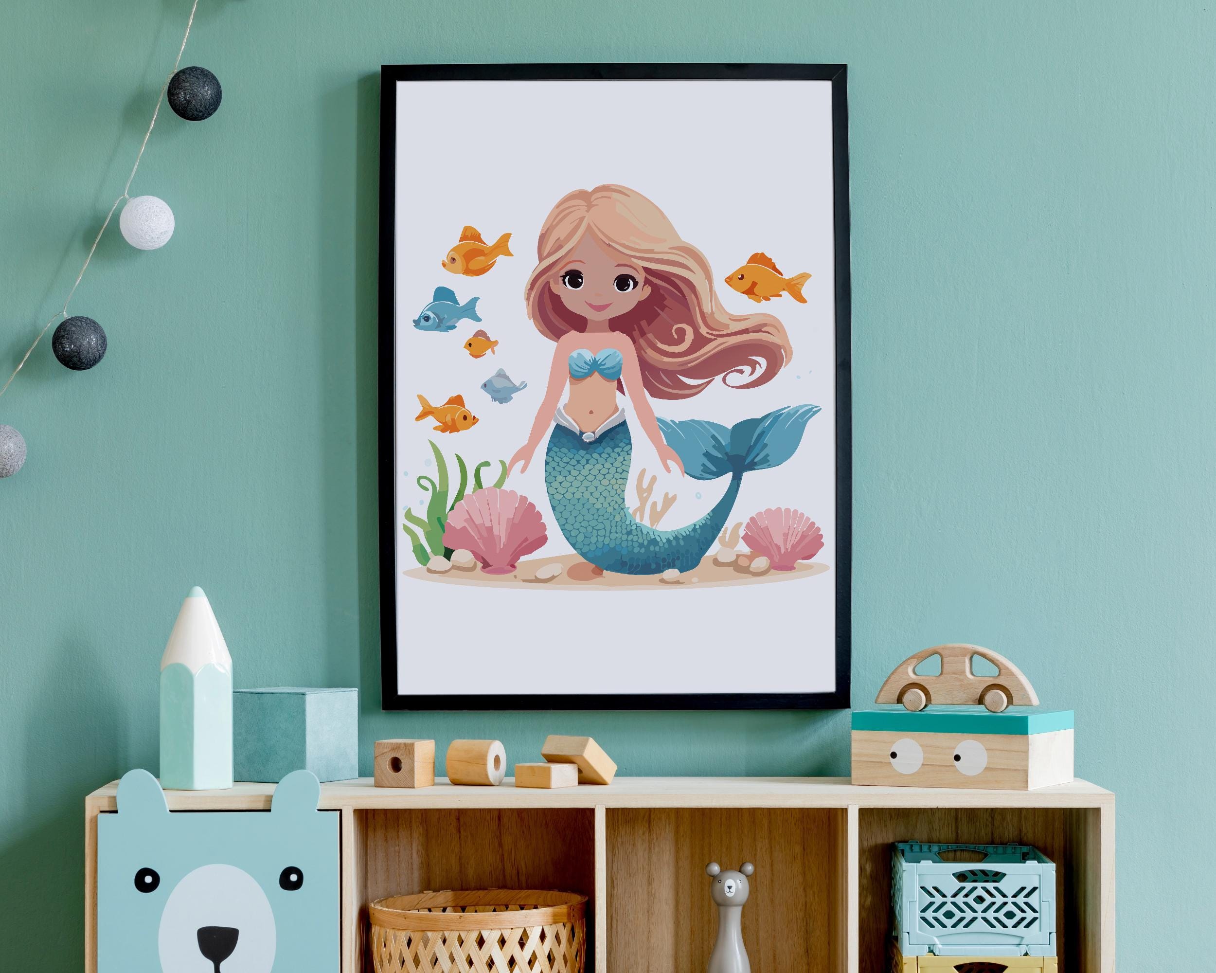 Cute mermaid wall art featuring a smiling mermaid with long blonde hair, blue tail, and ocean friends like fish and seashells, perfect for kids’ room decor or nursery printable.