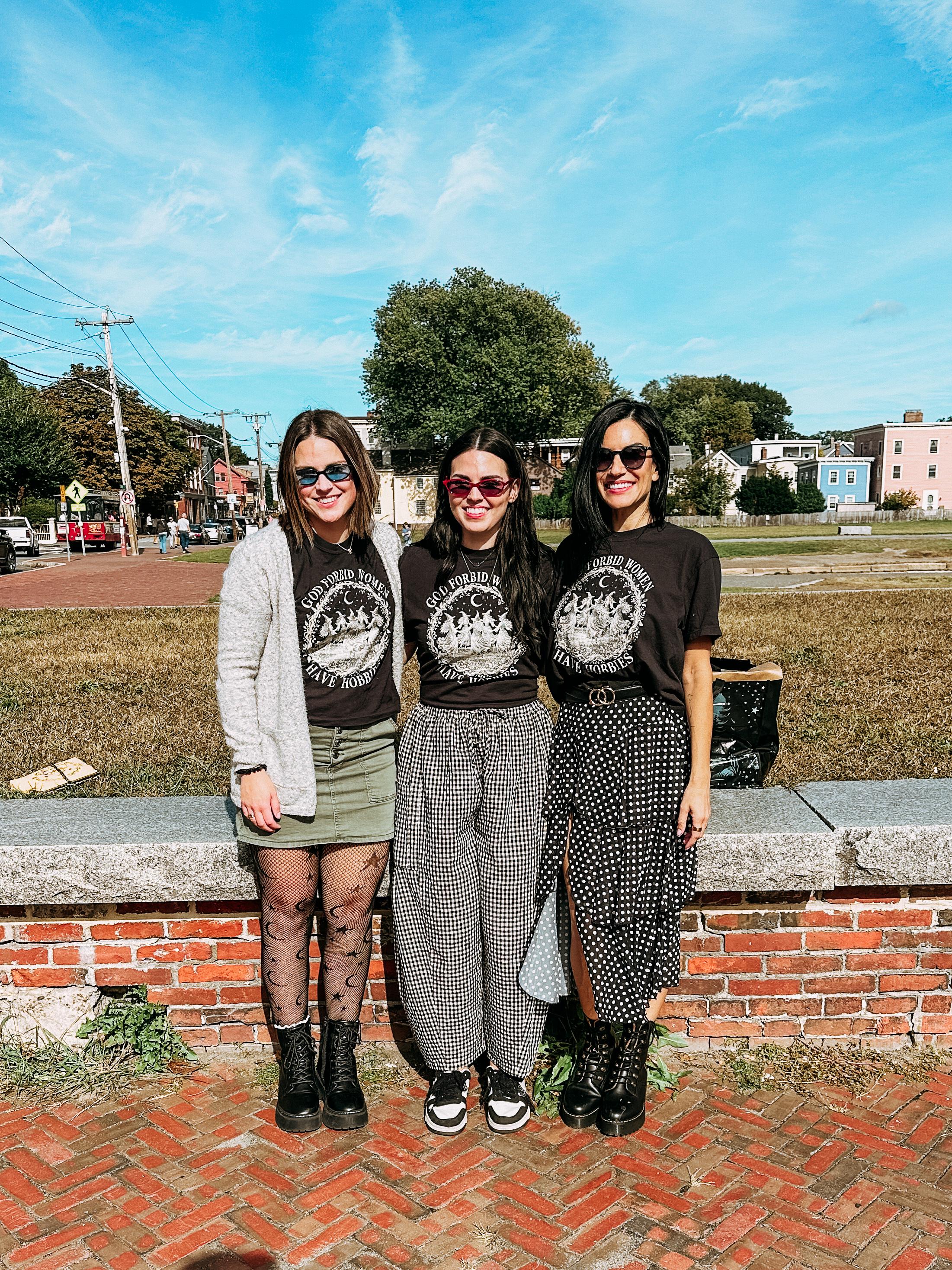 a coven of witches wearing shirts that say god forbid women have hobbies in Salem, MA