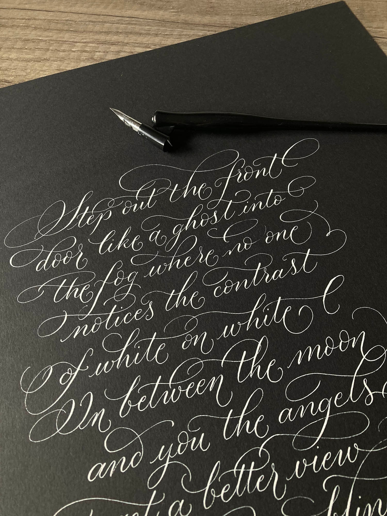 Modern calligraphy in white on black with a wonderful flourished lettering style