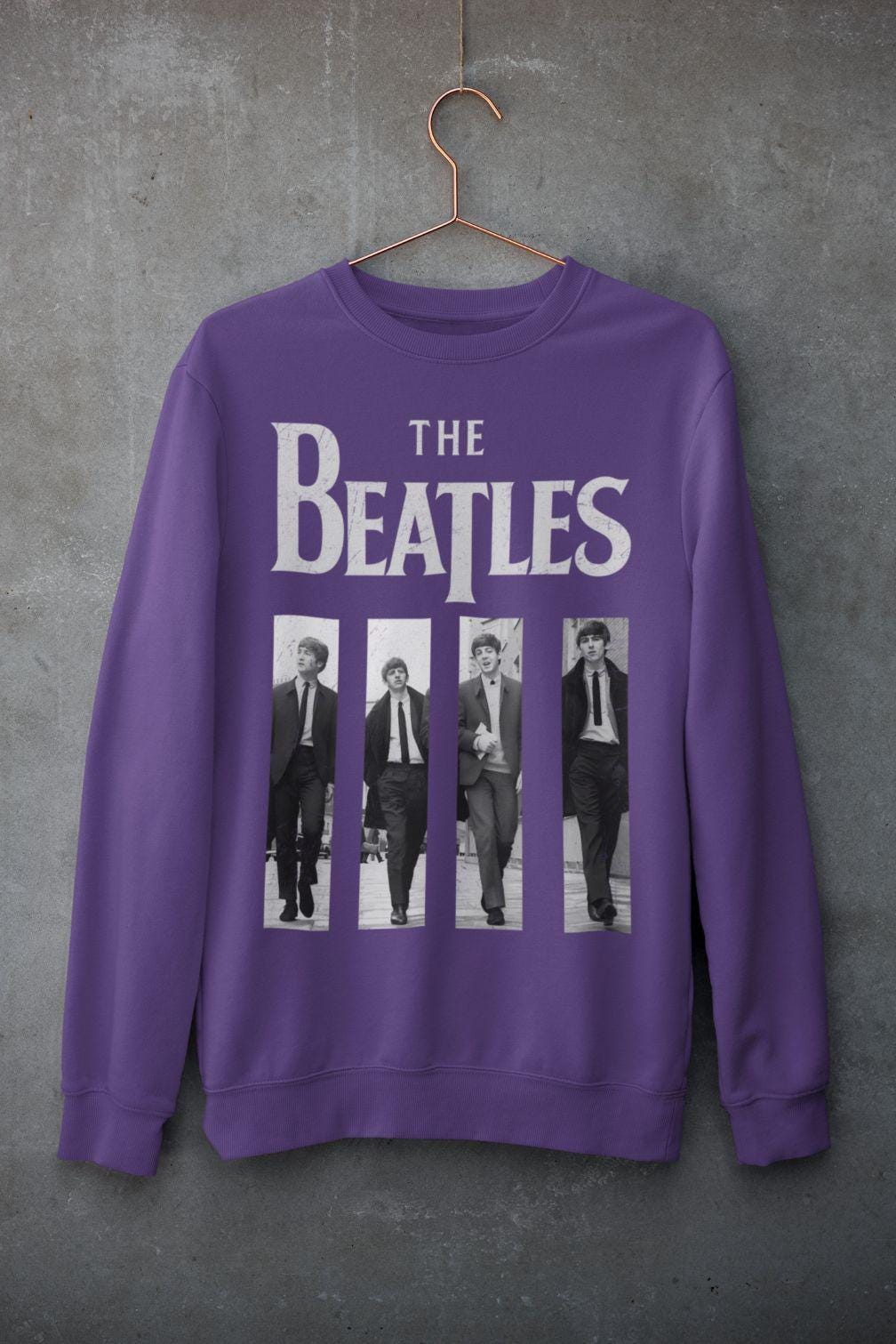 Outdoor mockup: gray crewneck featuring 60s British beat inspired four-panel black-and-white graphic.