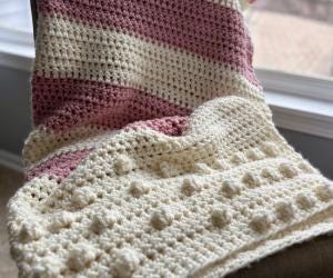 The Blush & Bobbles pink and white striped crochet blanket