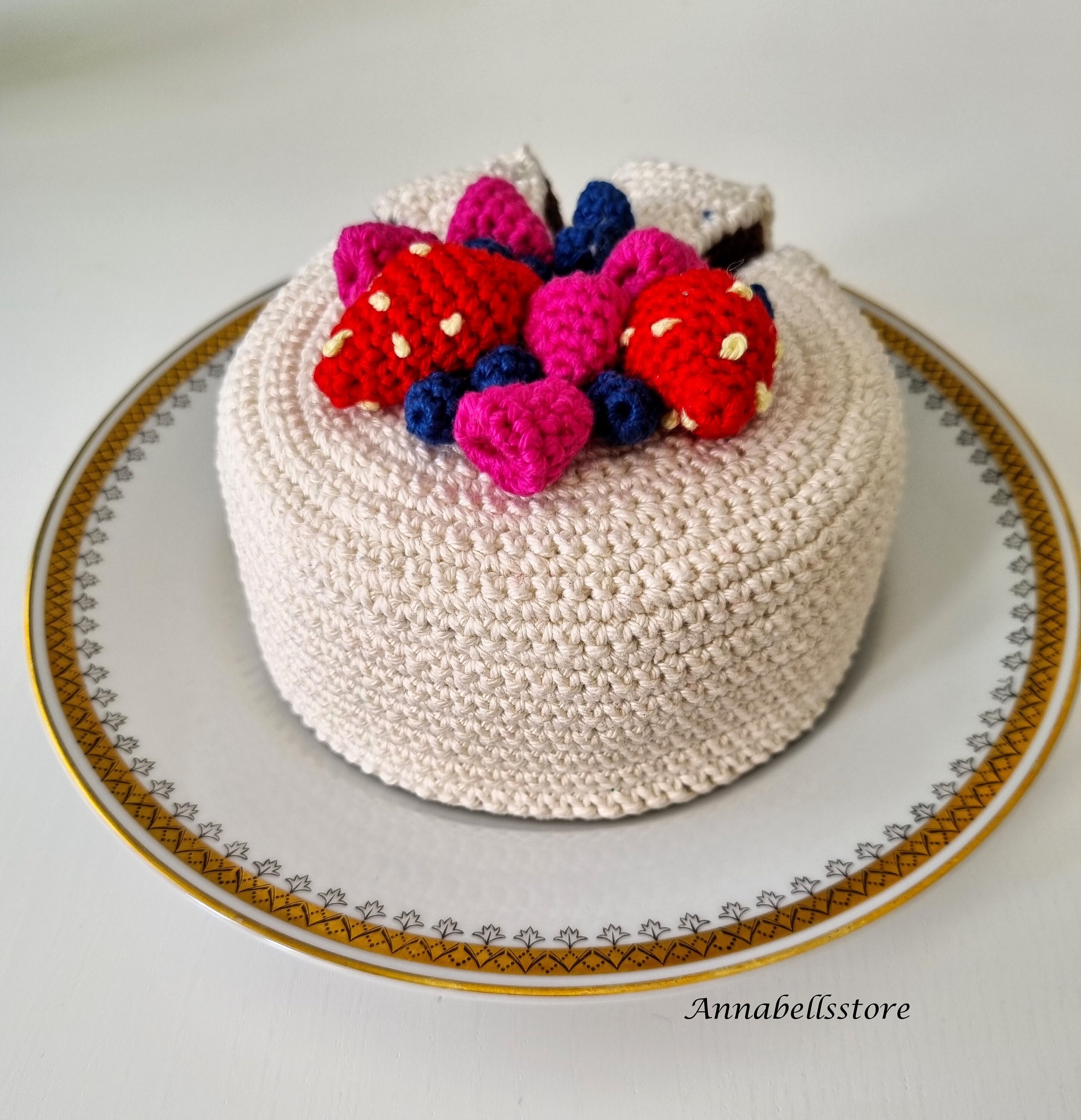 crocheted cake with icing and fruits
