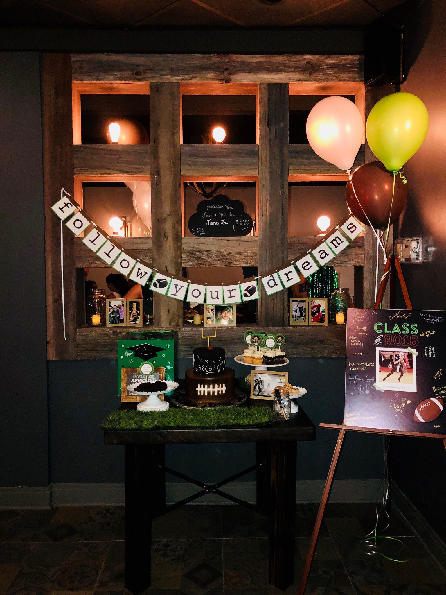 Follow your dreams graduation banner with football decorations and balloons