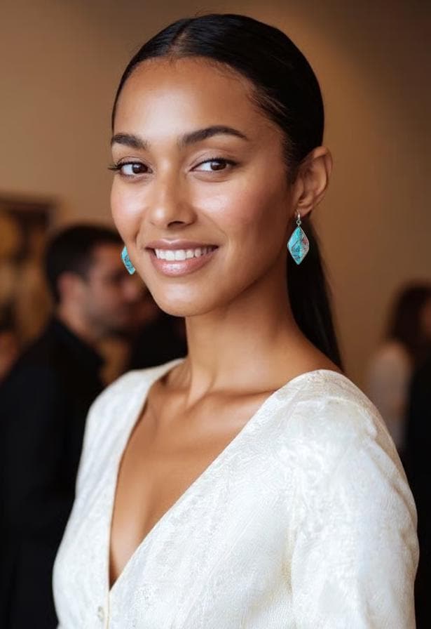 woman in white dress wearing bold chrysocolla statement earrings