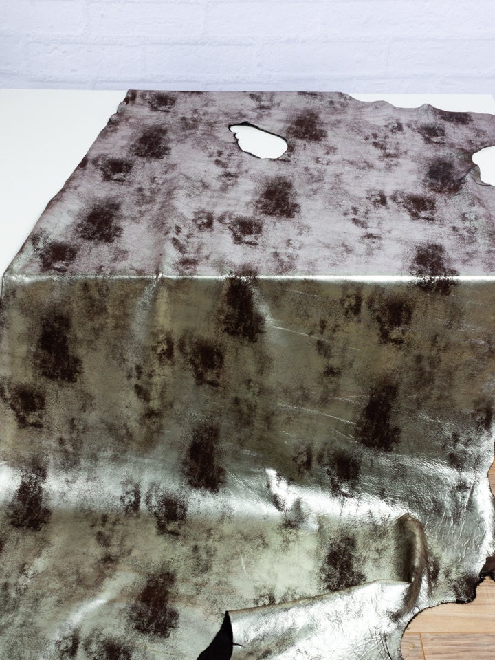 hide of copper foil leather showing distress and spots in leather.