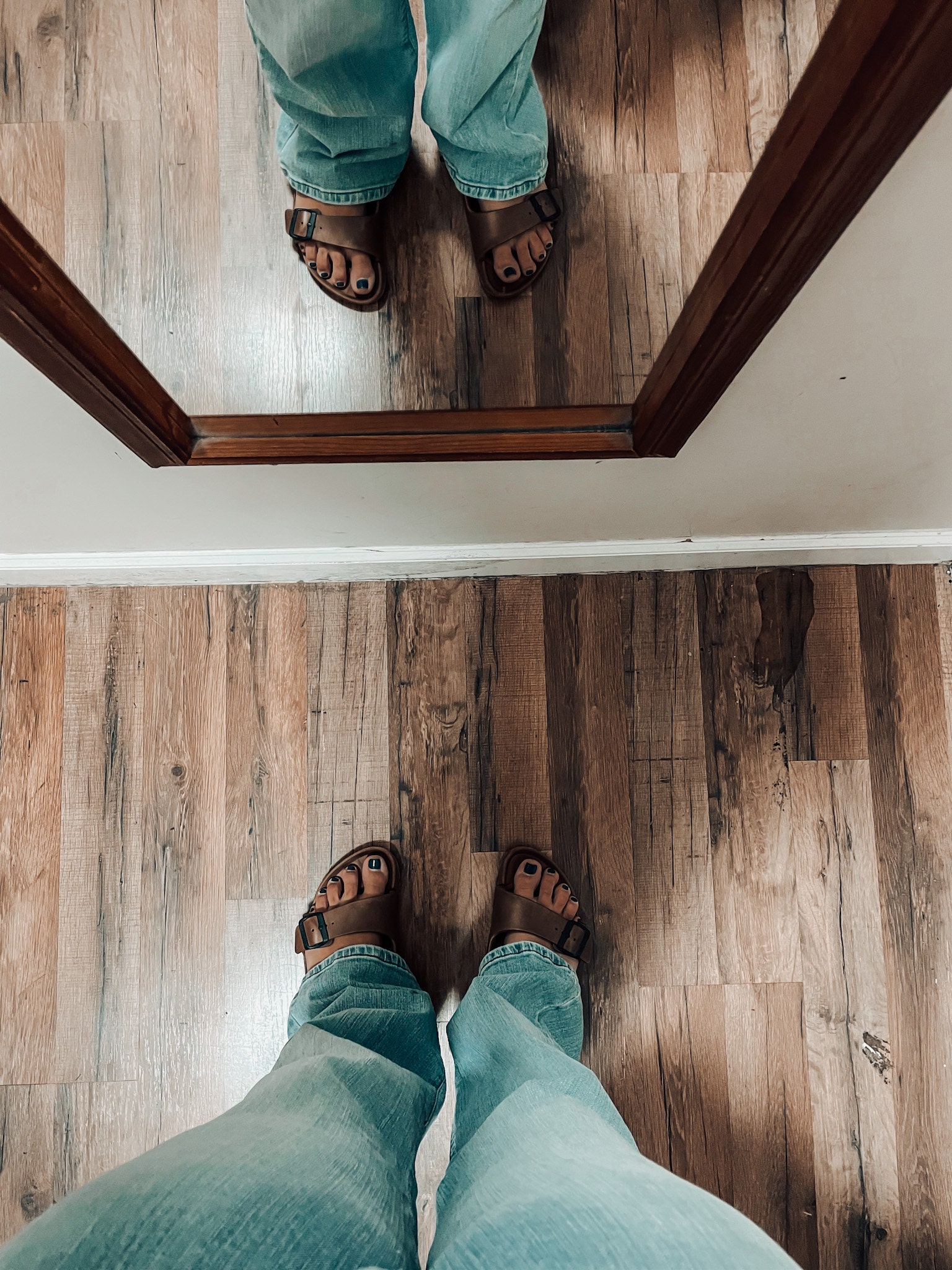 woman wearing flare jeans and birkenstocks