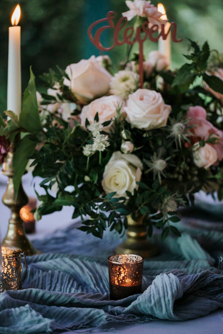 Moody earthy tones and dusty blue tablecloth for wedding with blush tones