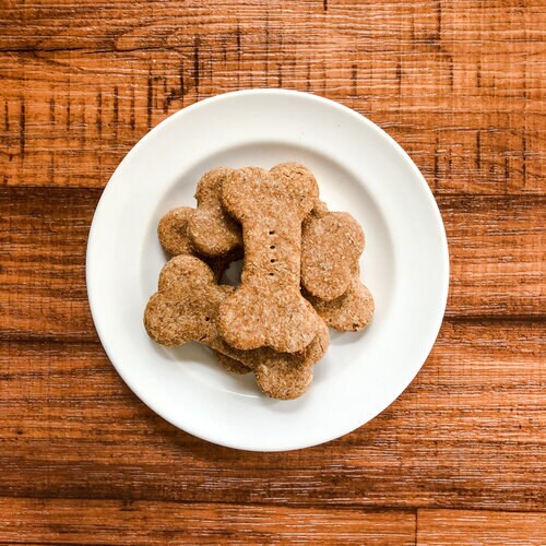 Bone shaped dog biscuits on white plate