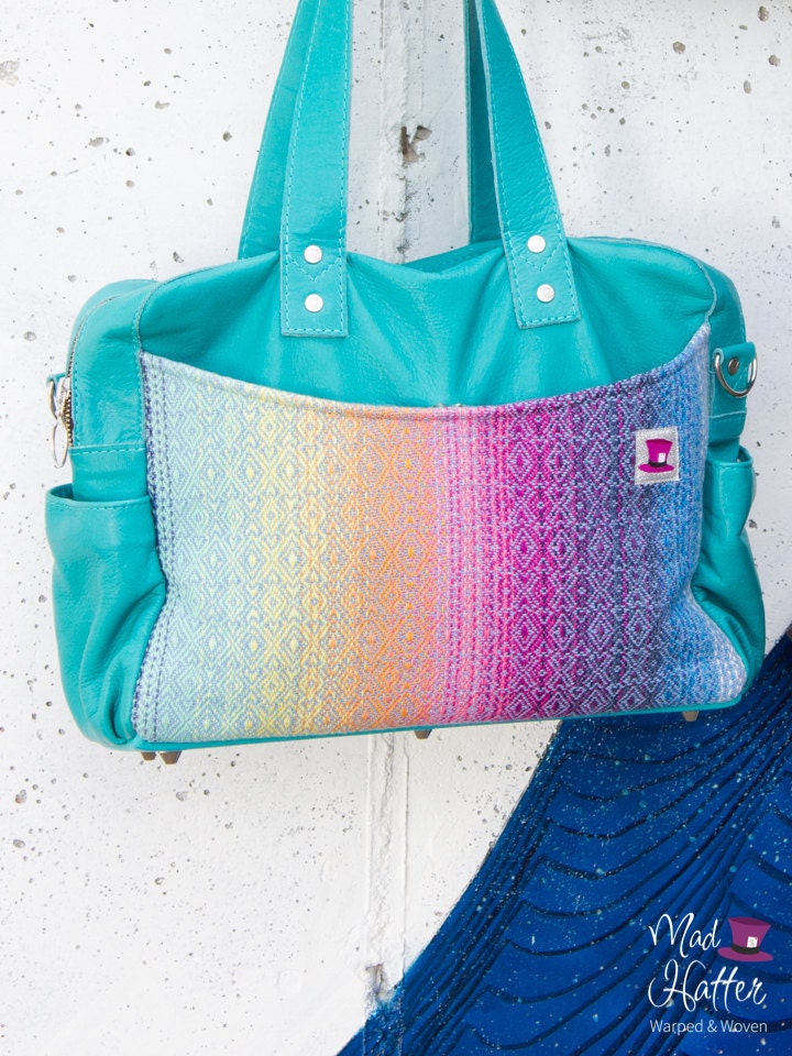 Mad Hatter Warped & Woven Lovato handbag with a rainbow colourway and turquoise leather.