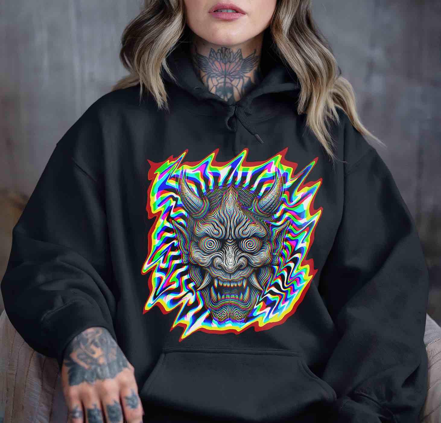 Oversized black hoodie printed with hypnotic oni mask and neon glitch border; cozy goth rave wear for cool nights and afters.
