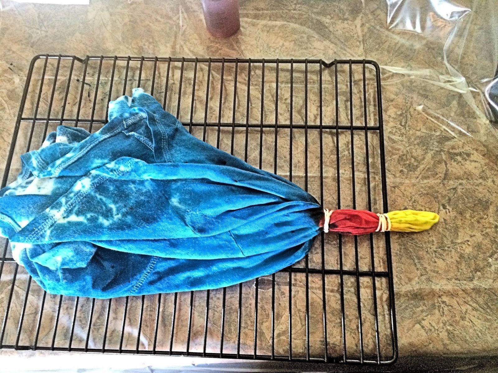 Dye applied to the banded shirt — yellow center, orange ring, turquoise outer shirt