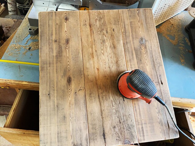 A pallet of reclaimed wood to use for the wedding sign