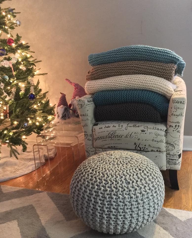 A big stack of chunky knit blankets