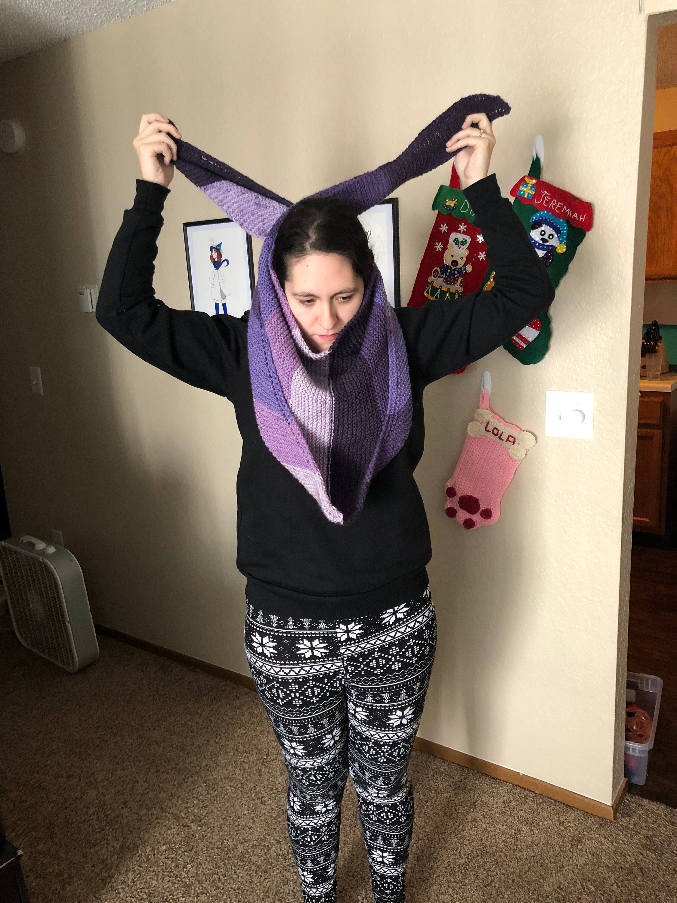 Woman putting on purple knit scarf
