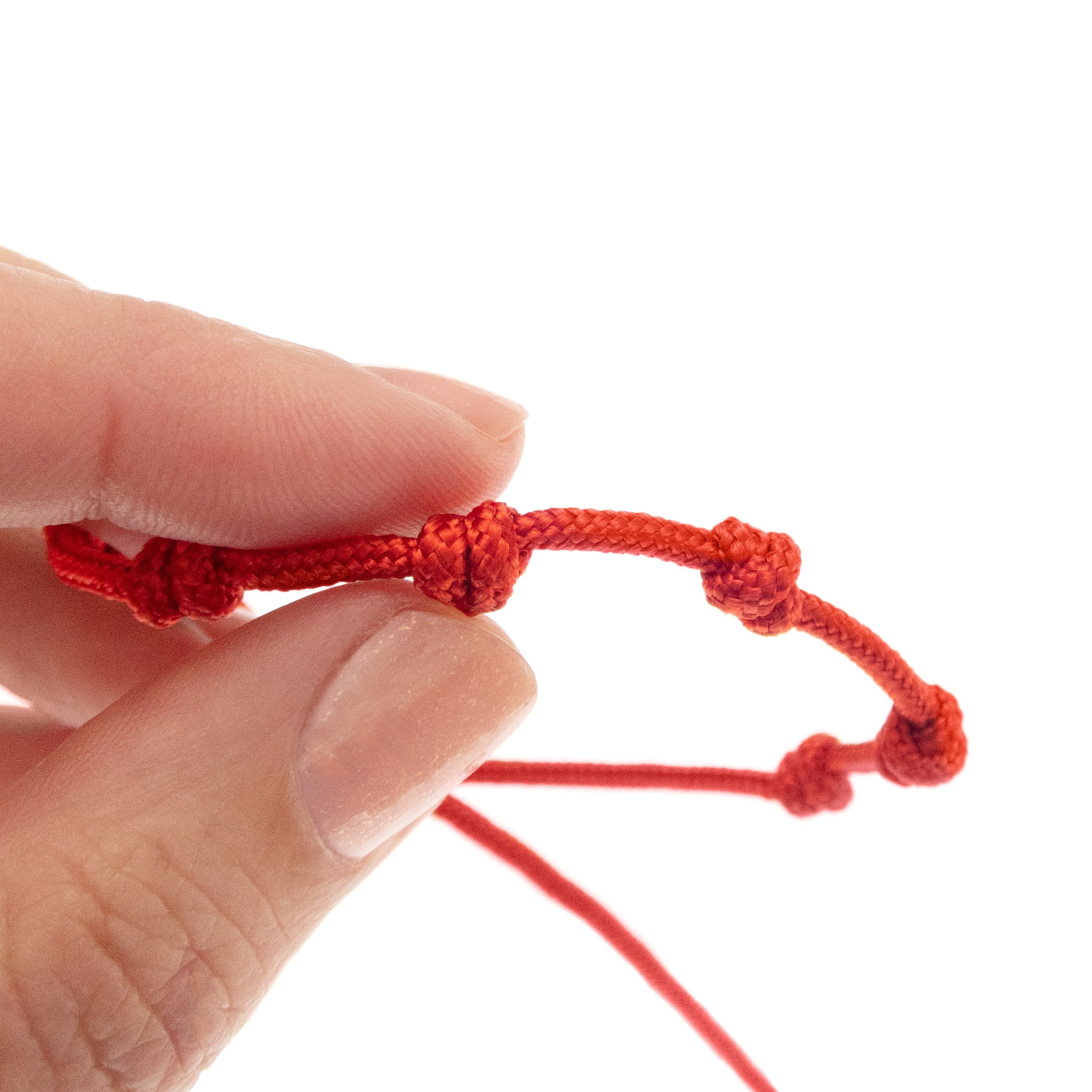 handmade red string bracelet with 7 knots