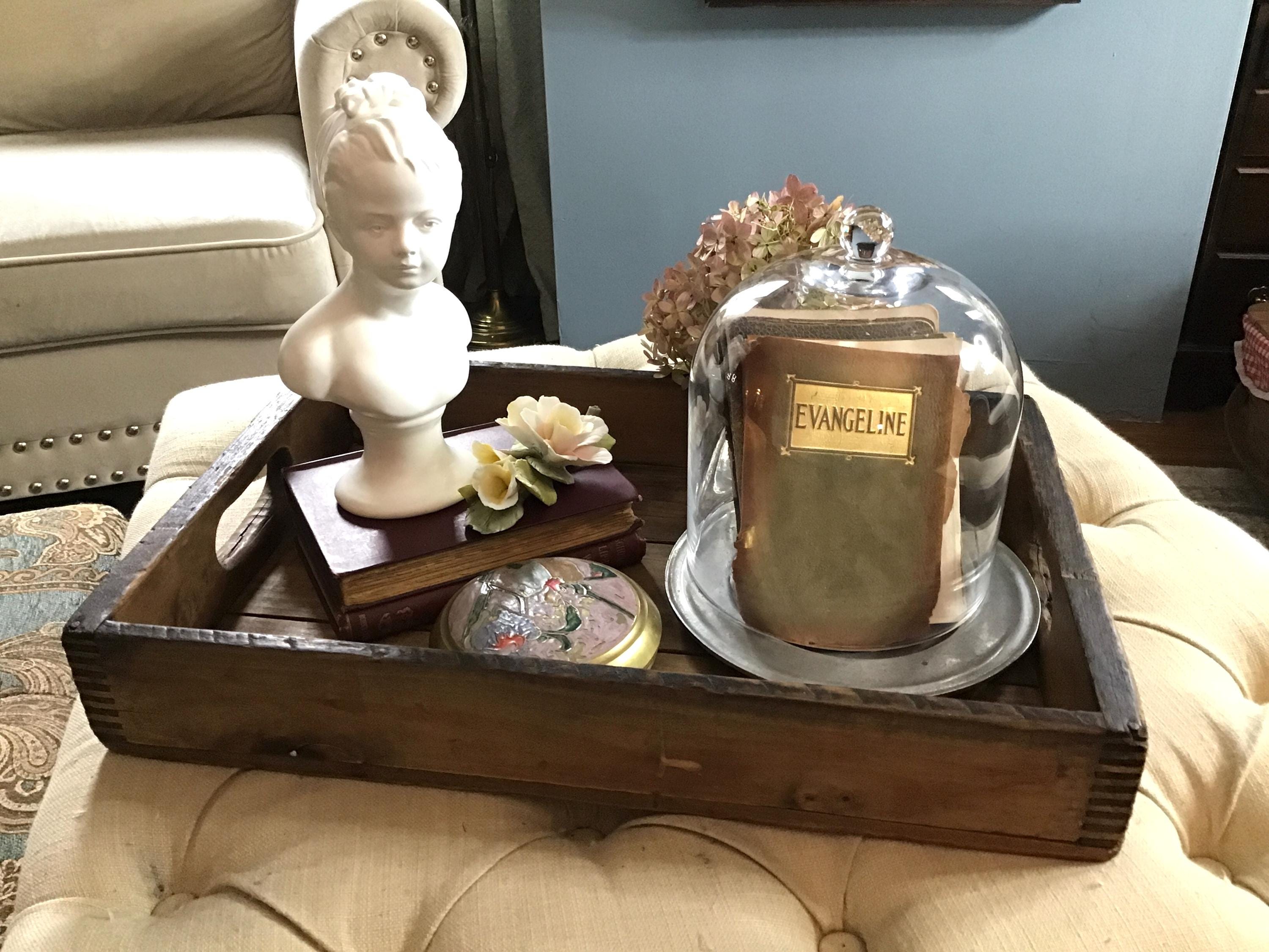 Layering on book stacks and tucking items into cloches are perfect in tray vignettes