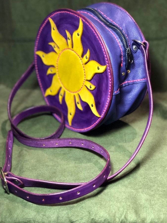 A purple, pink, and yellow purse