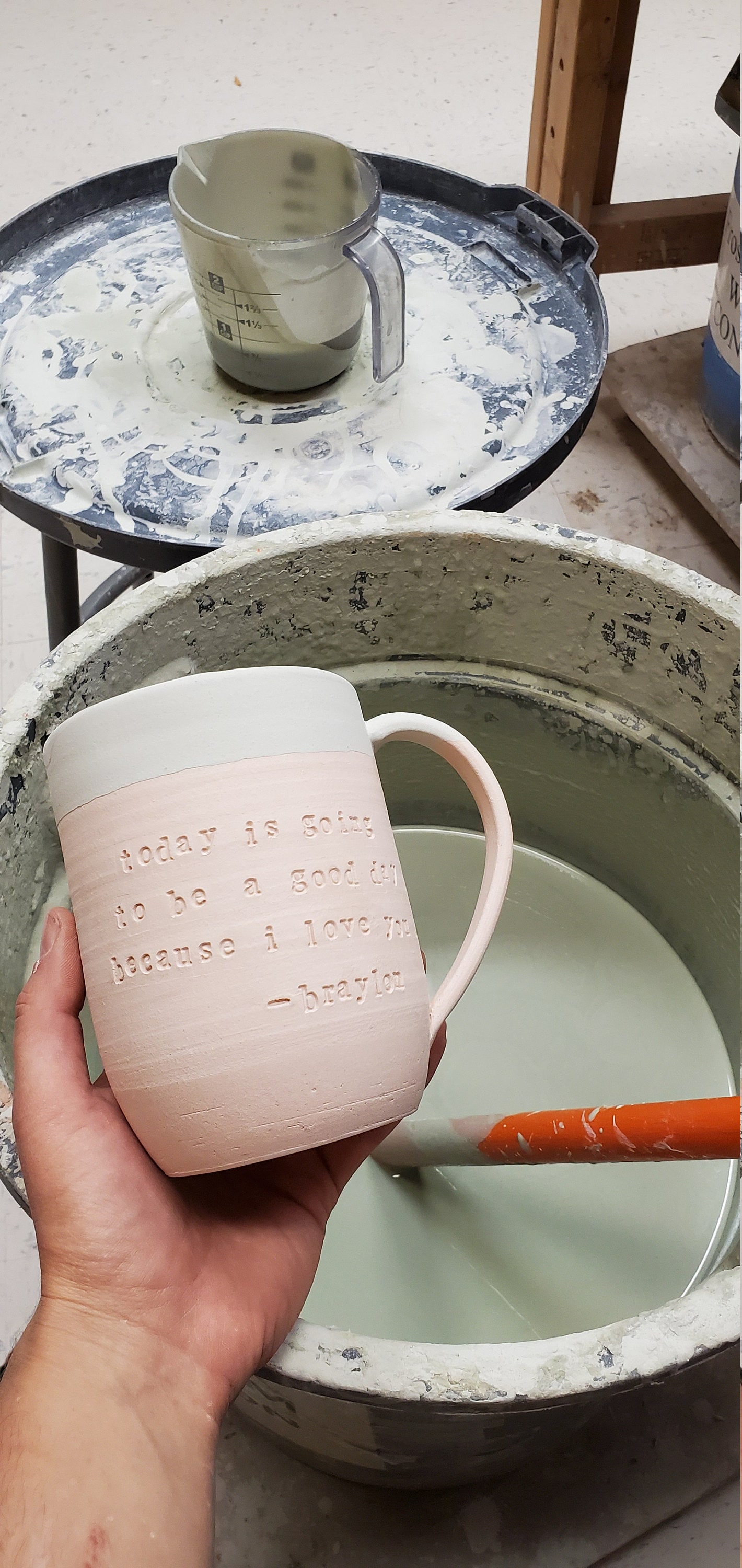 a custom quote mug with glaze but not fired yet