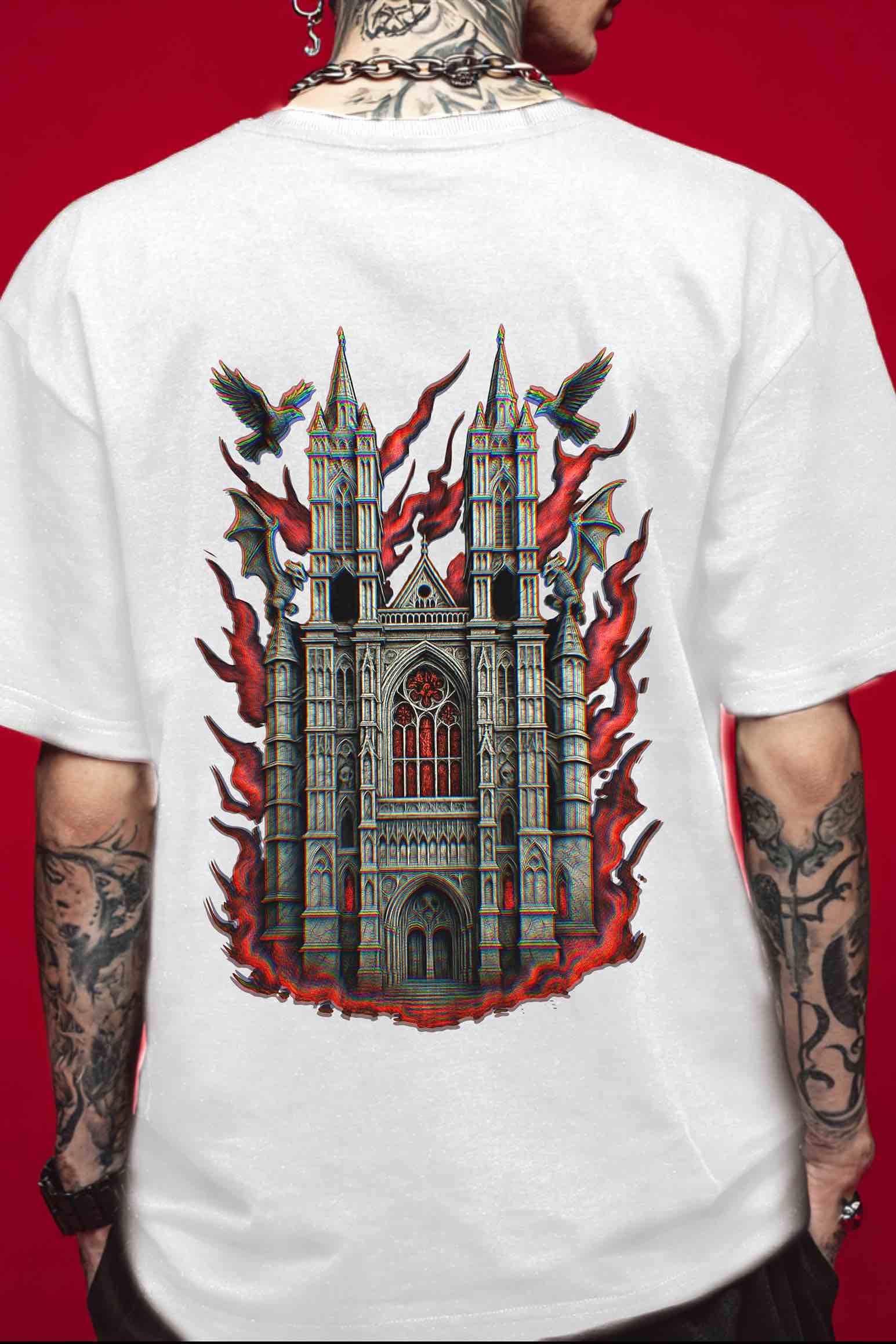 White t-shirt, back view, male model, studio red backdrop — Large Gothic cathedral graphic with crimson flames, ravens, and rose window; high-detail dark art for cathedral lovers and British history fans.